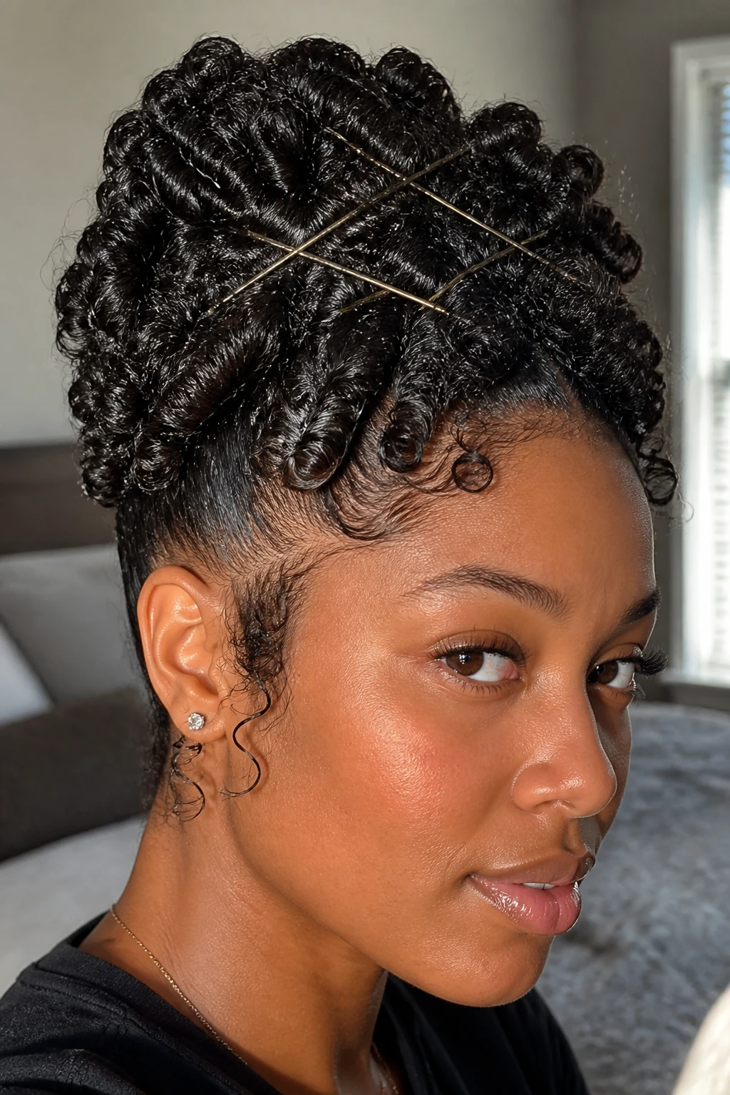 Close-up of a real woman with a crown-updo of coils pinned in a crisscross pattern