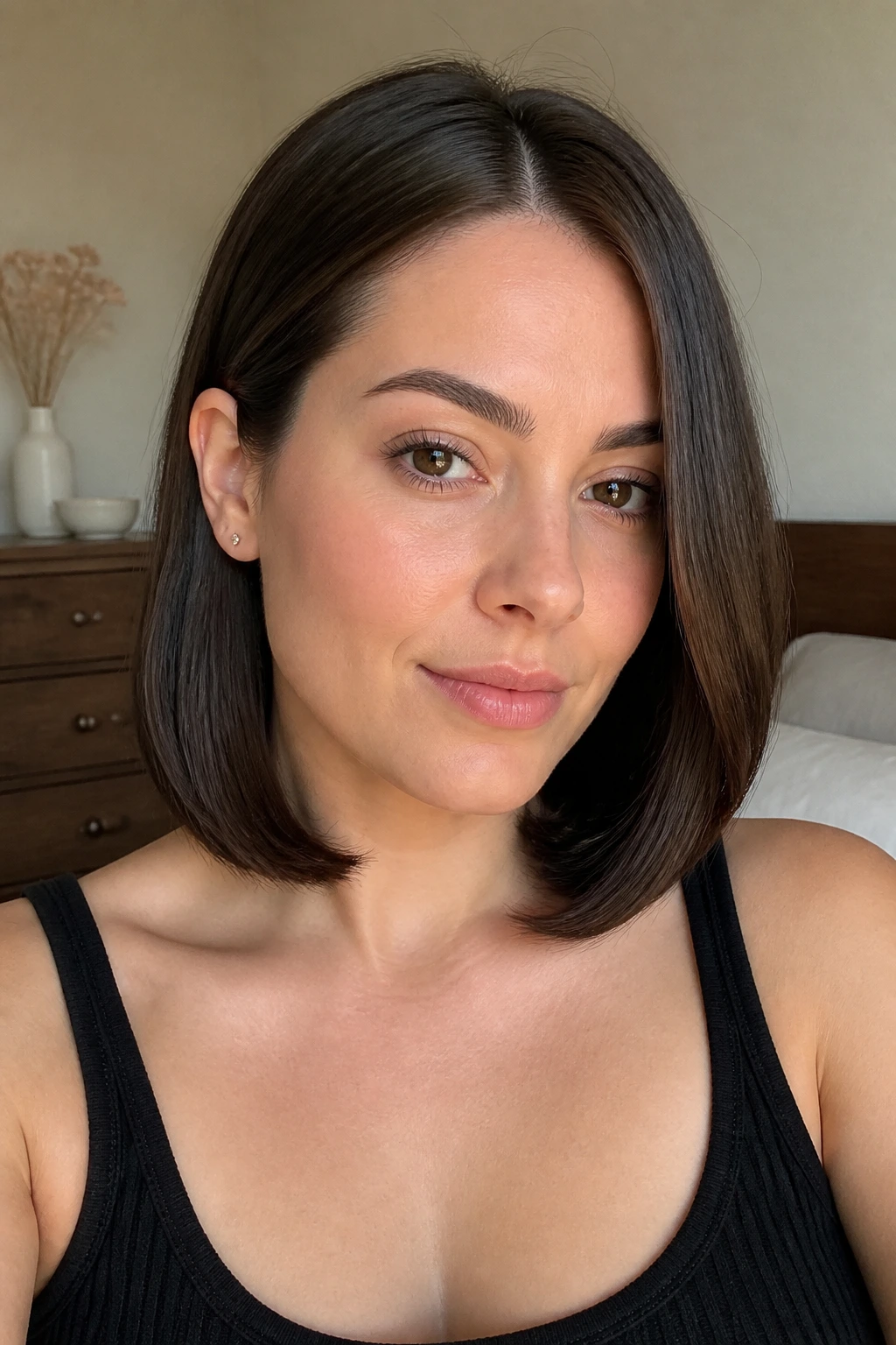 Close-up of a real woman's sleek collarbone cut with one side tucked behind the ear