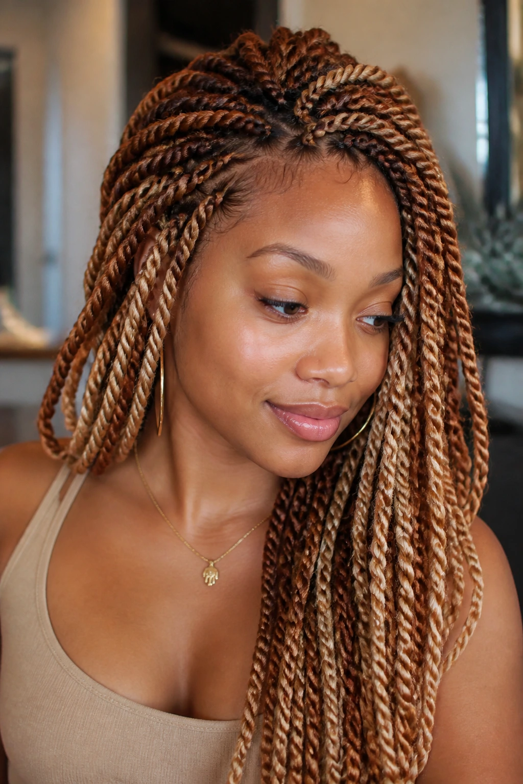 Close-up portrait of a woman with copper and caramel Senegalese twists.
