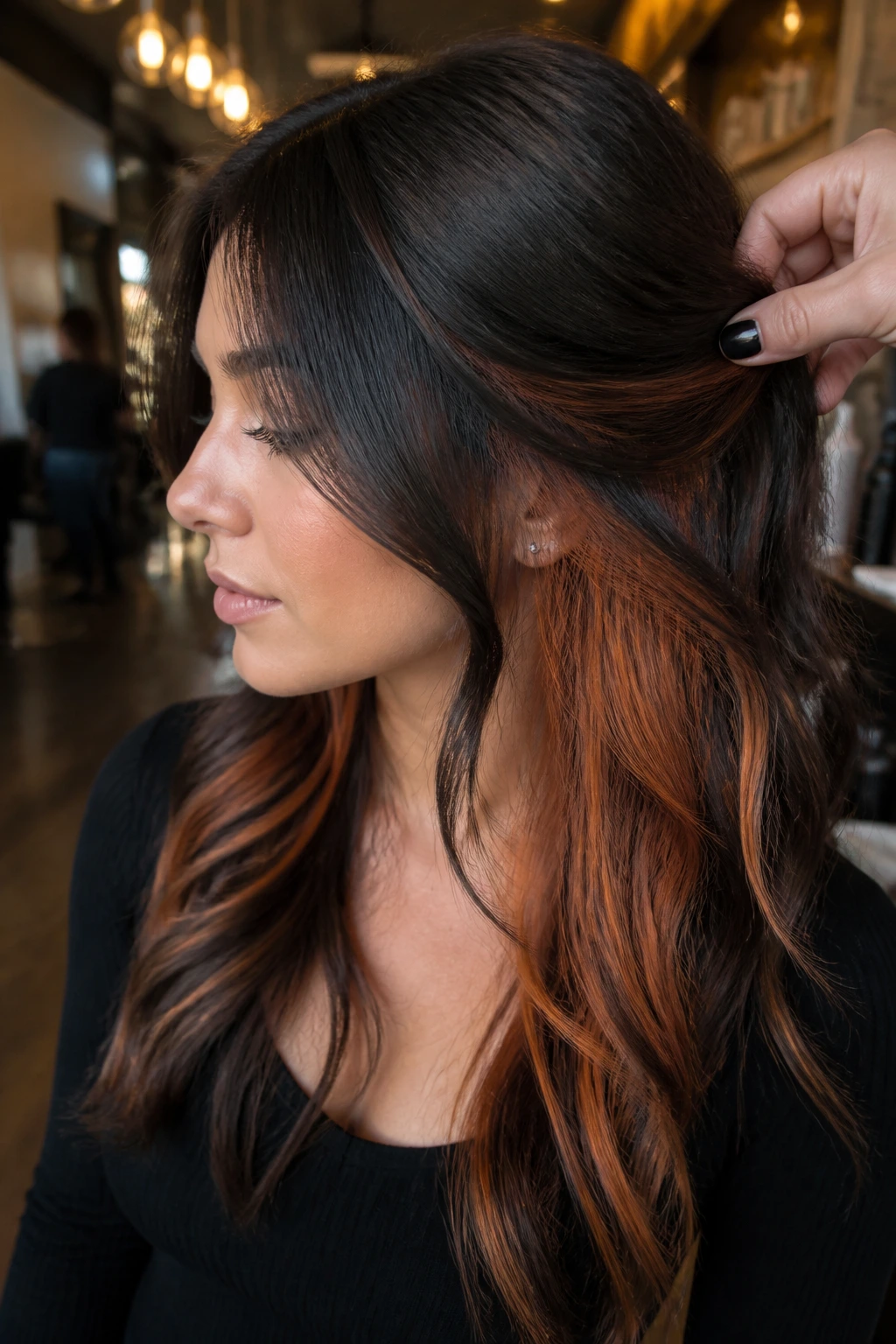 Close-up of dark hair with copper peekaboo panels under the top layer