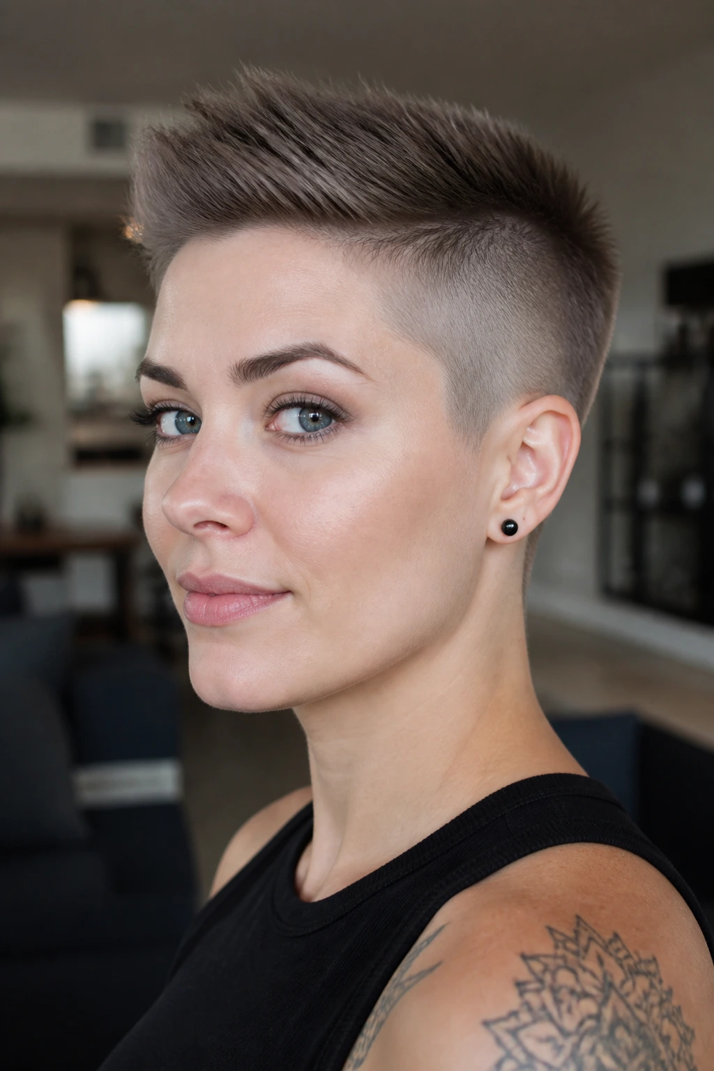Real woman with crew-cut buzz hybrid hairstyle in a soft-lit room