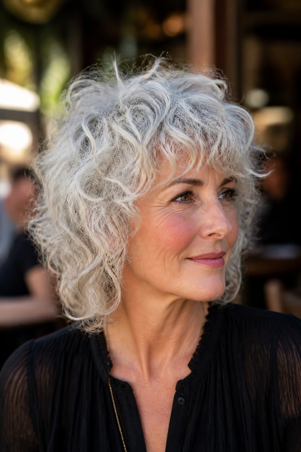 Real woman with platinum curly halo wolf cut, close-up outdoors
