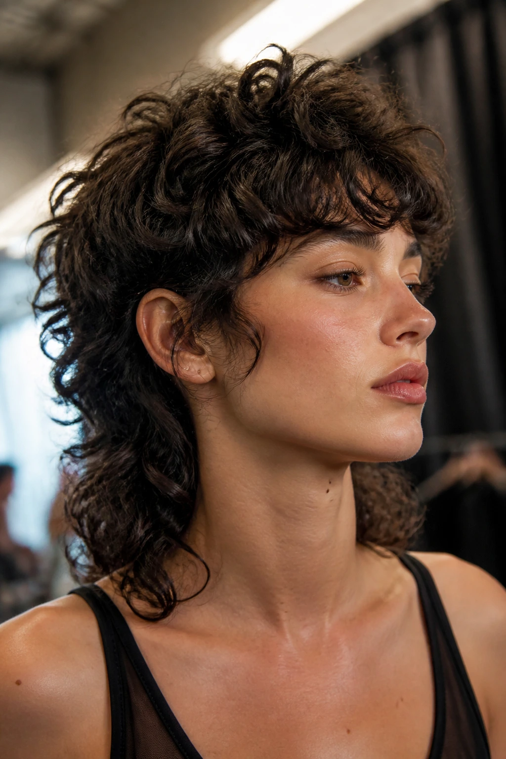 Portrait of real person with dynamic curly mullet showing lift and motion