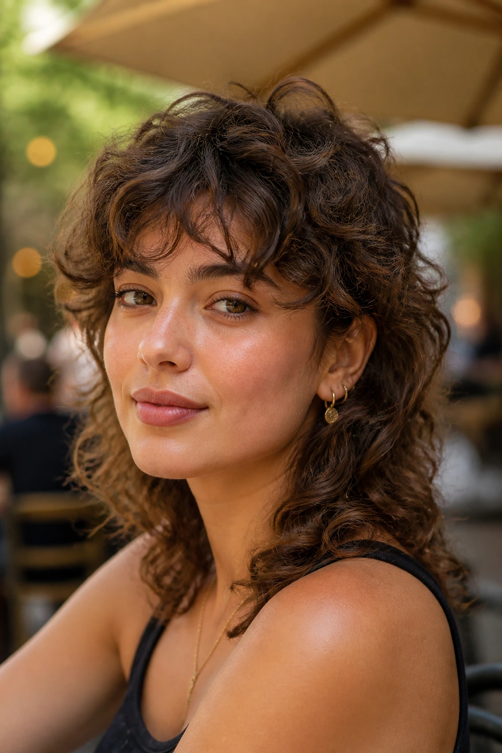 Close-up of a real woman with curly mullet and soft fringe