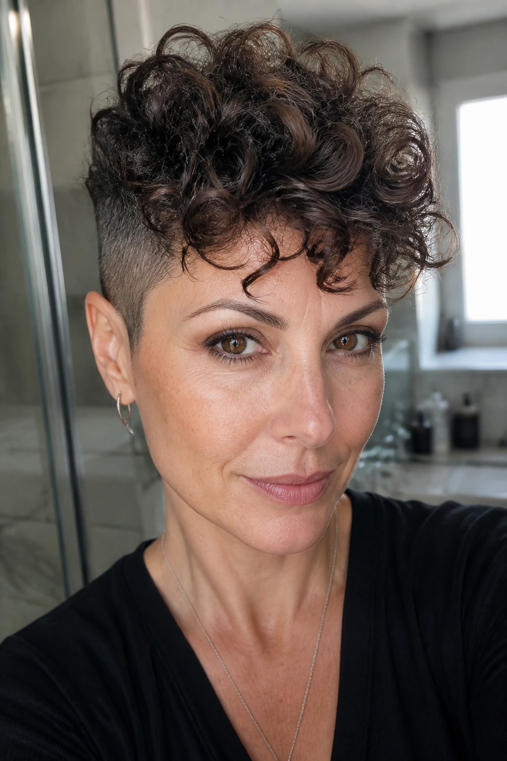 Close-up portrait of a real woman with a curly undercut pixie and fuller top