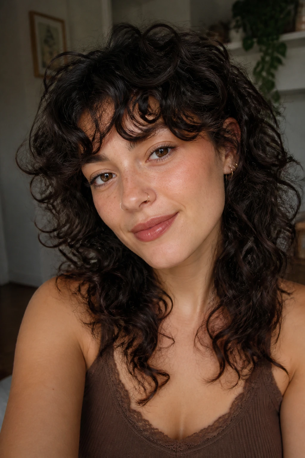 Portrait of a person with curly wolf cut and side bangs