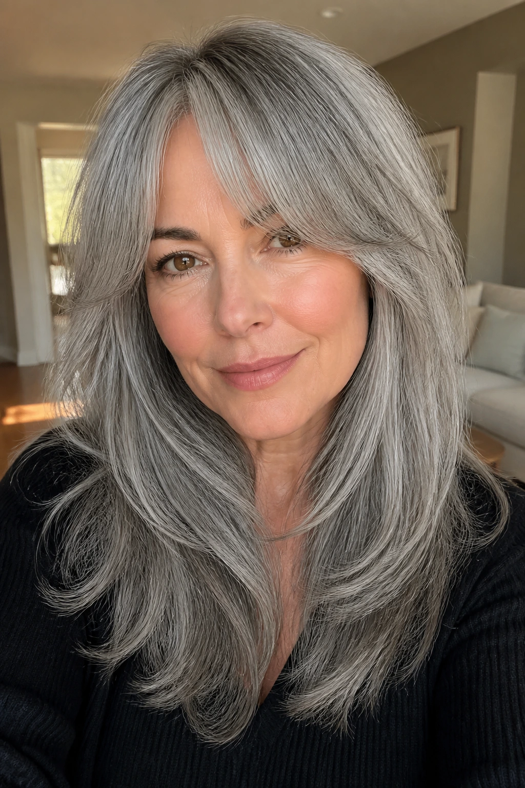 Real person with curtain bangs and long gray layers, portrait