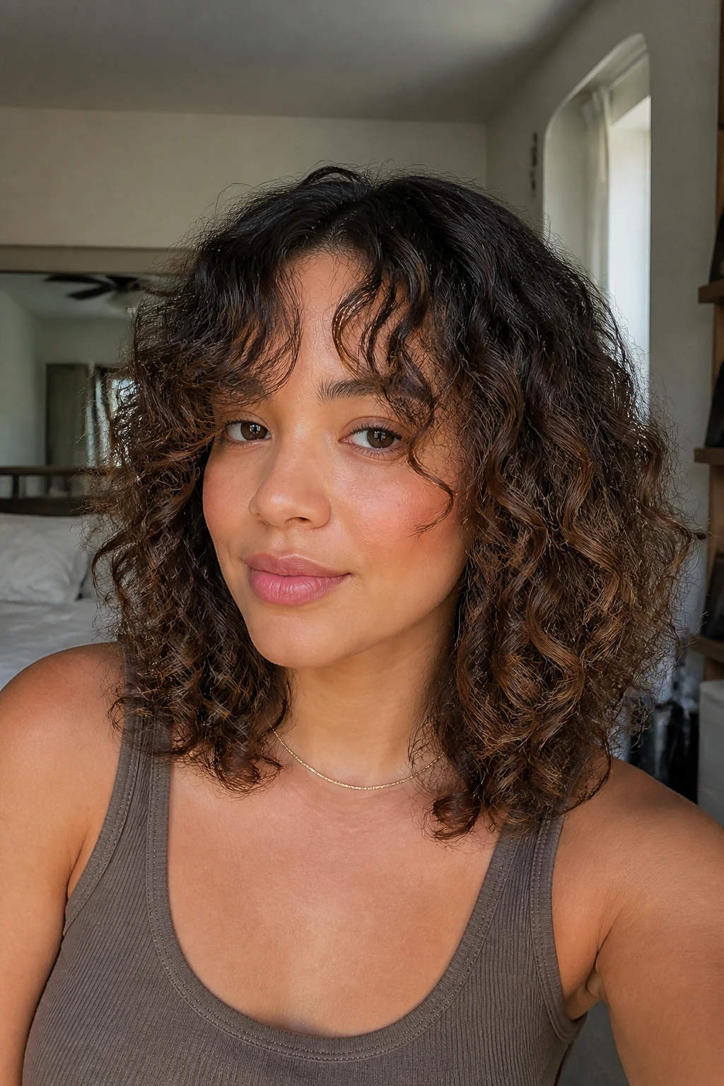 Close-up portrait of a real woman with curtain bangs and a lob hairstyle