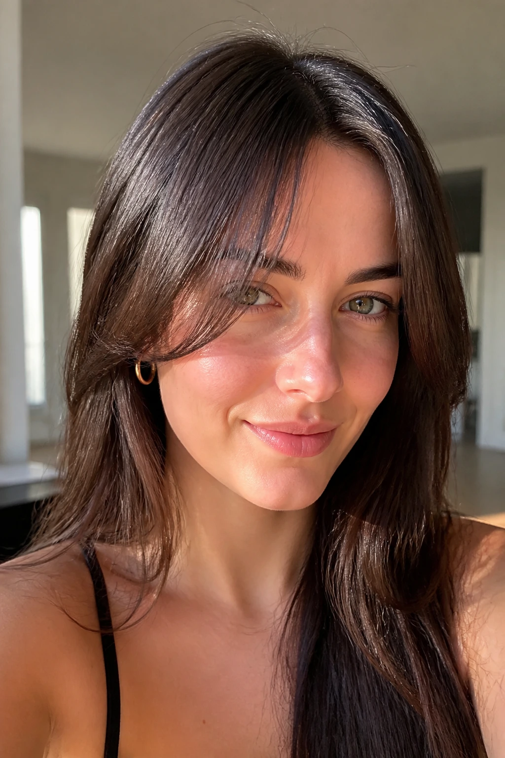 Close-up of a real woman with grown-out curtain bangs.