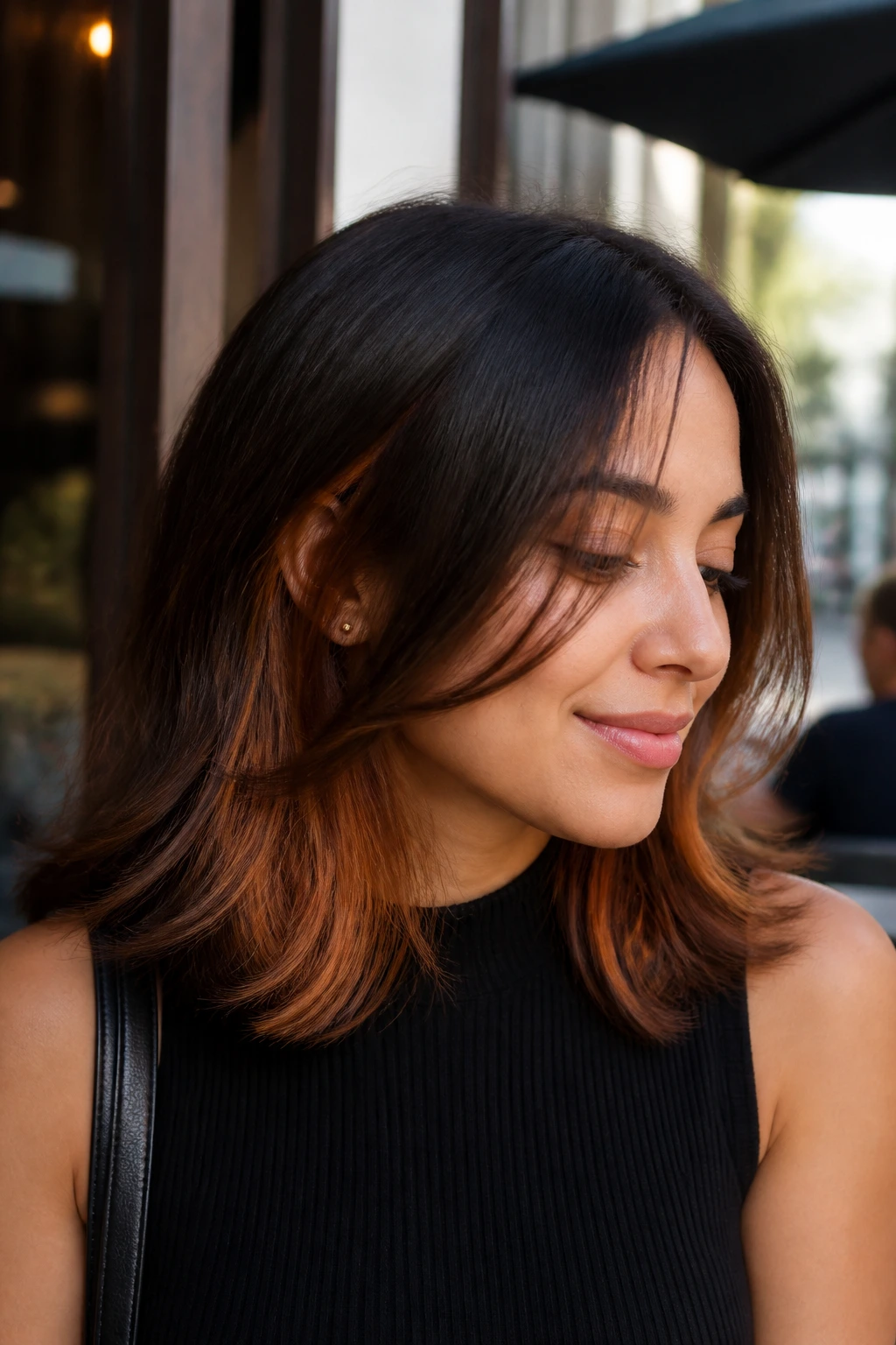 Real person showing dark chocolate copper peekaboo panels in medium-length hair.