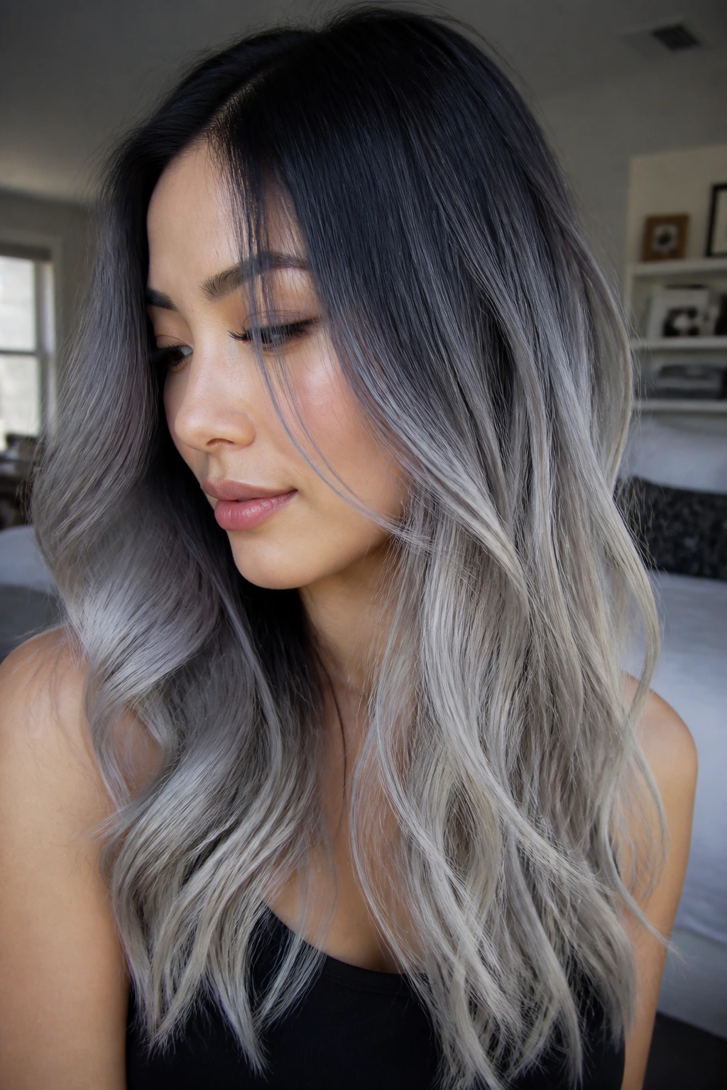 Close-up portrait of a real person with dark roots fading to silver smoke ends