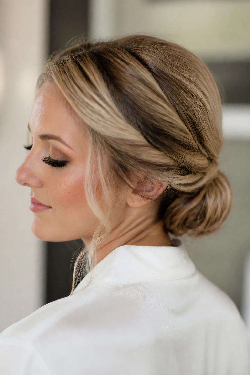 Real woman with deep side part and twisted low bun