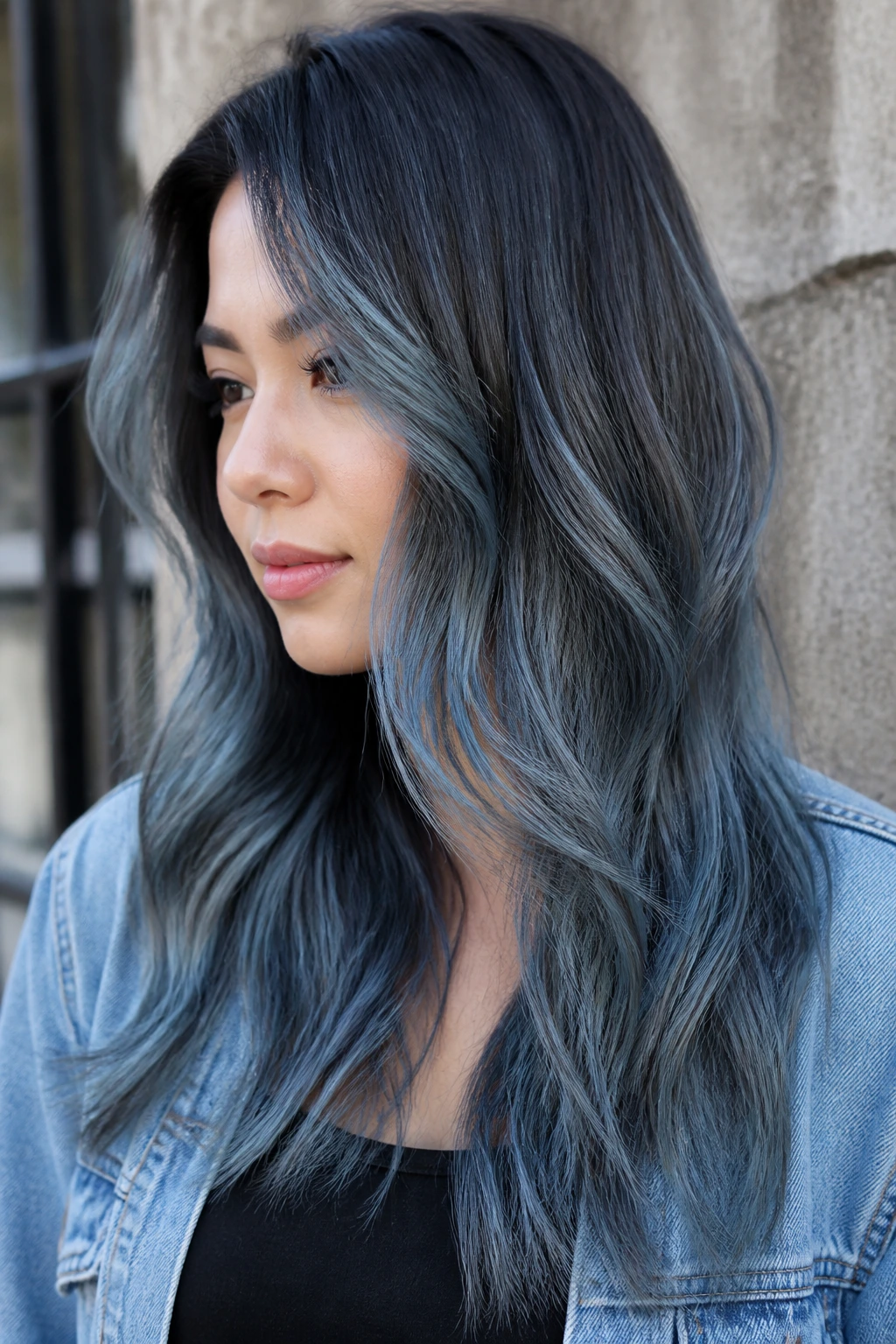 Woman with denim gray balayage hair in outdoor setting