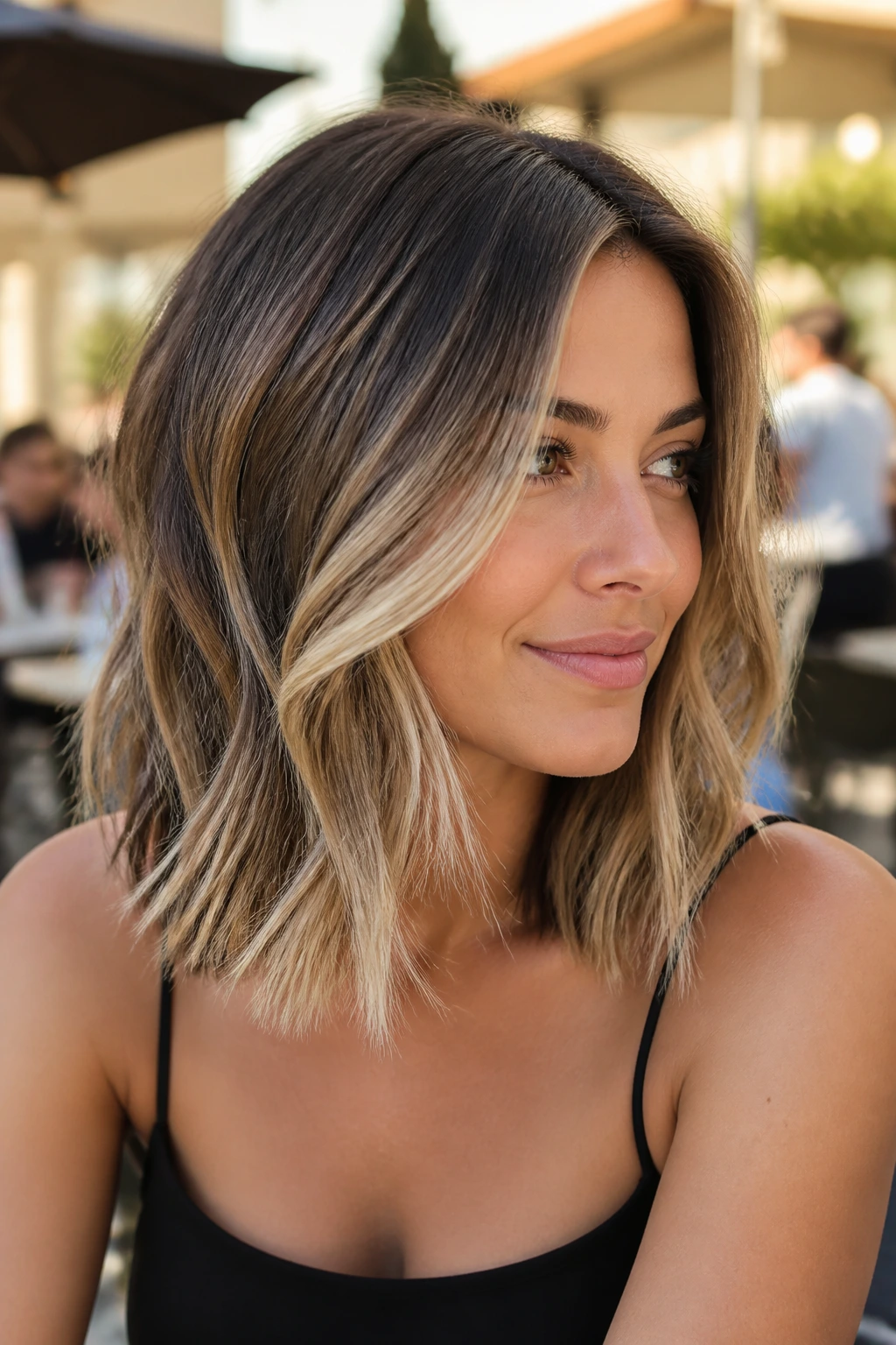 Dimensional balayage lob close-up on real woman outdoors