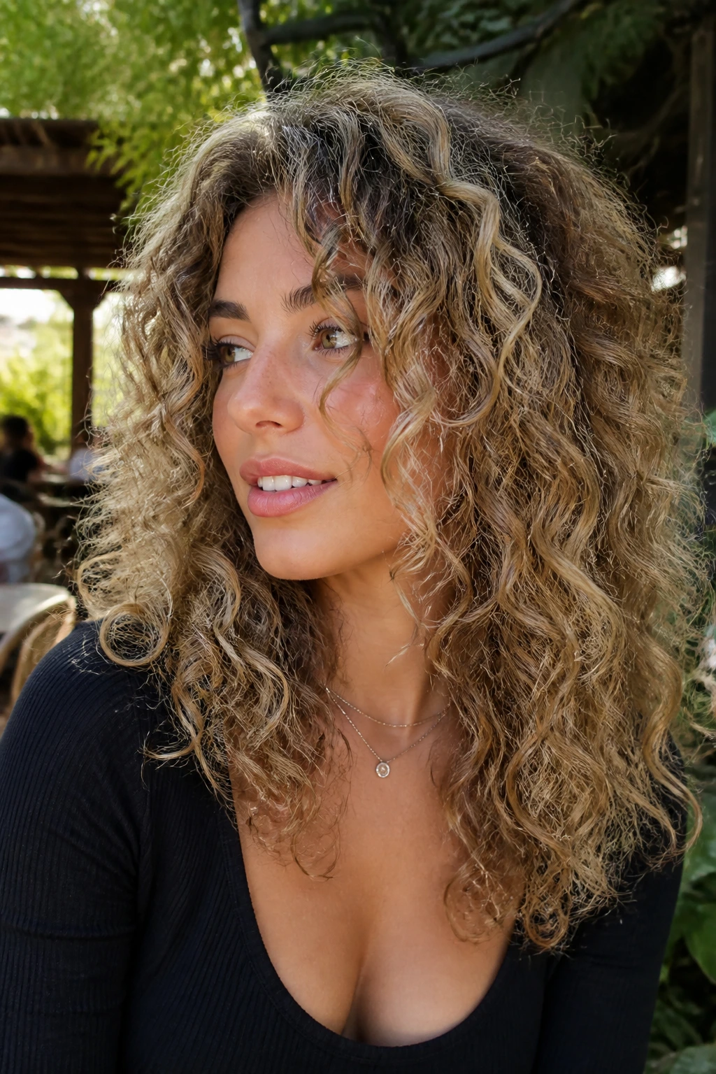 Close-up of dimensional beige curls with ribboned color and defined curl pattern.
