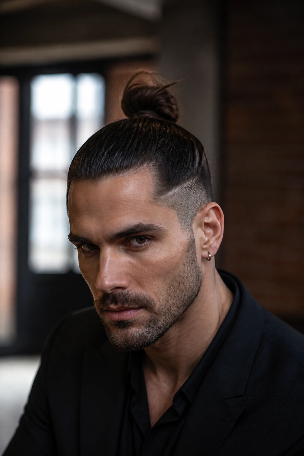 Close-up portrait of a man with an editorial top knot hairstyle
