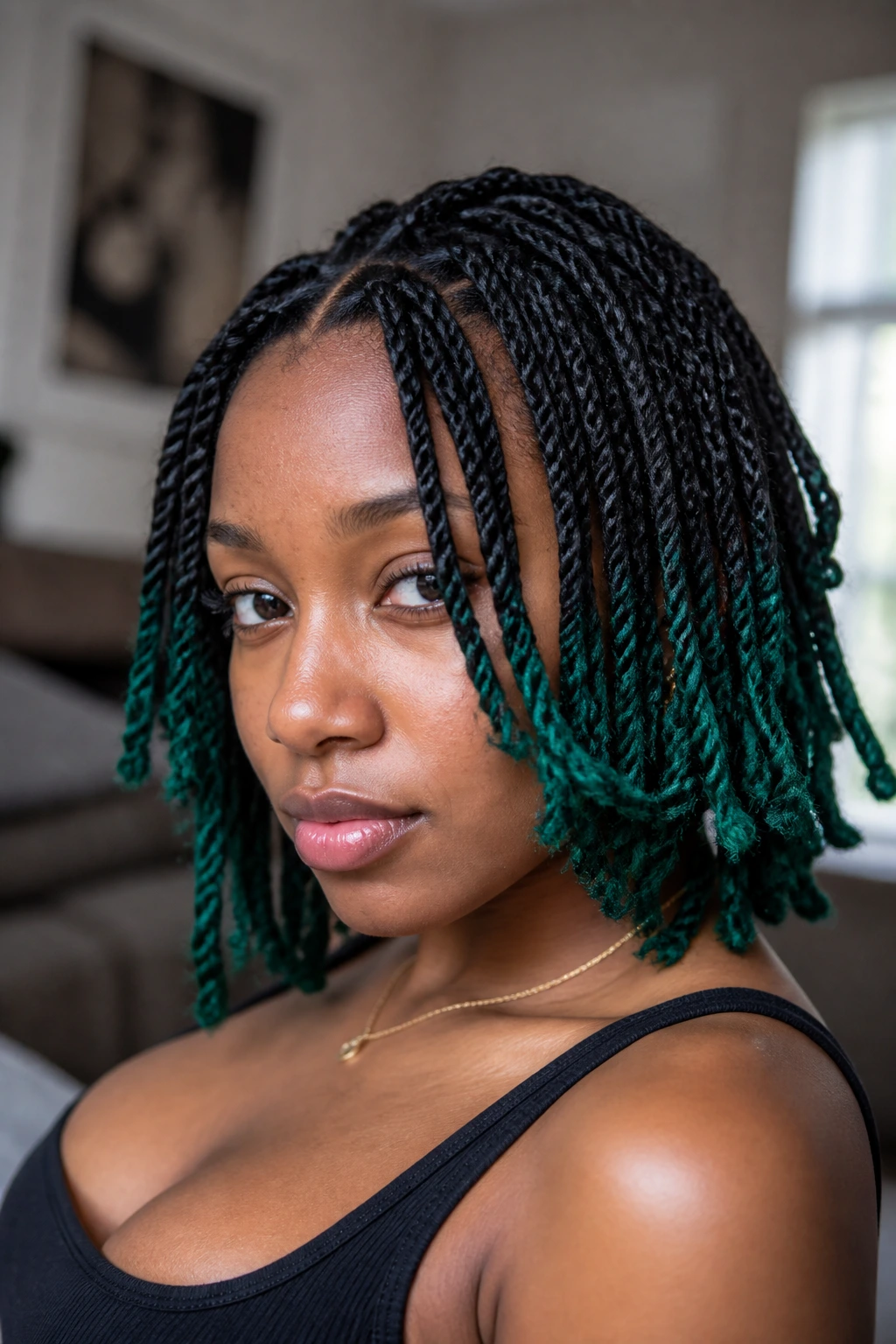 Close-up of a Black woman with emerald-tipped mini twists