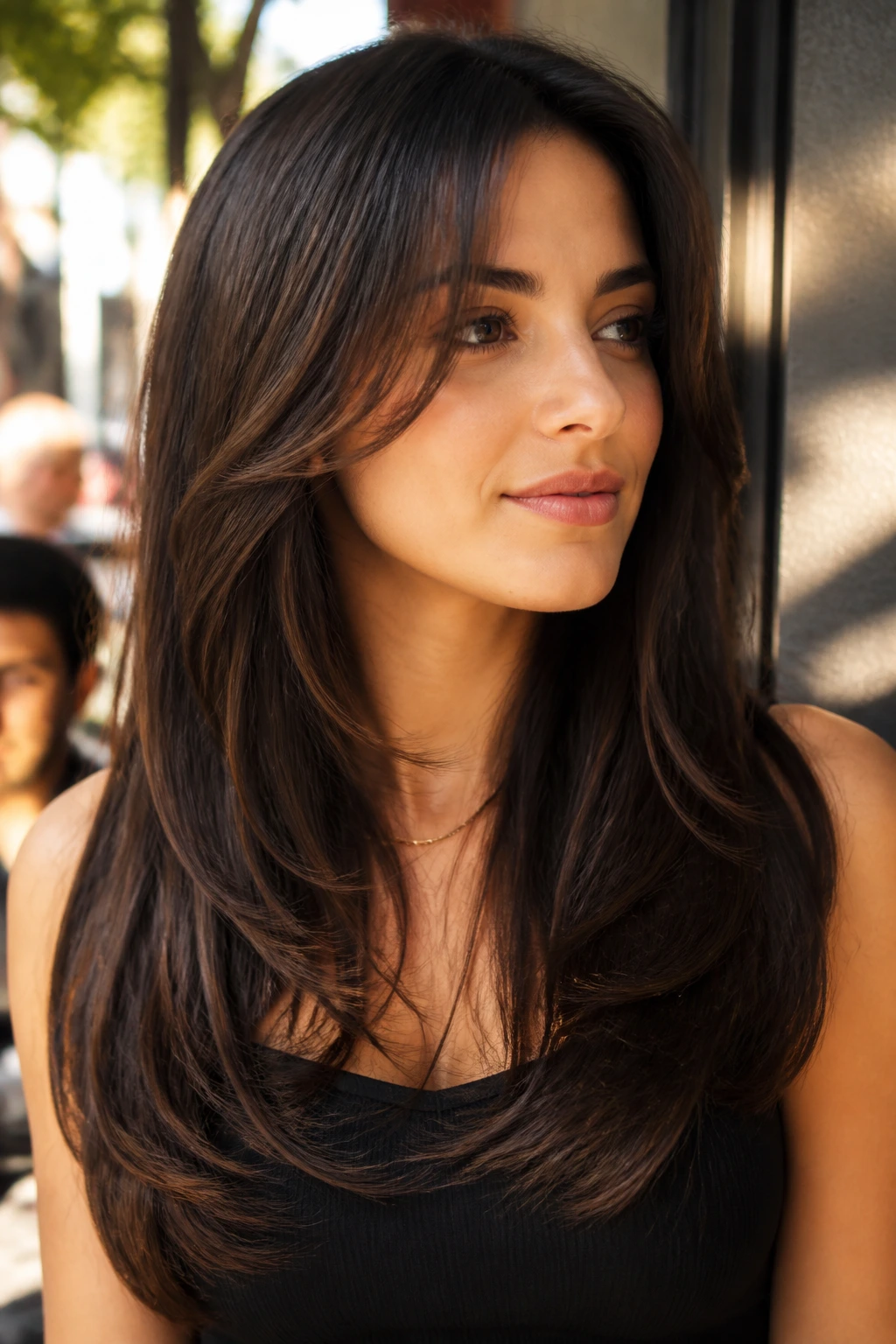 Portrait of a woman with espresso long U-layers in golden hour light