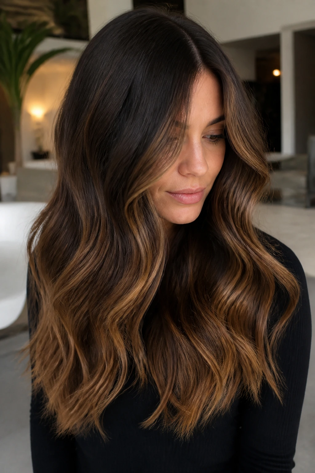 Close-up of long brunette waves with espresso-to-toffee balayage on a real person