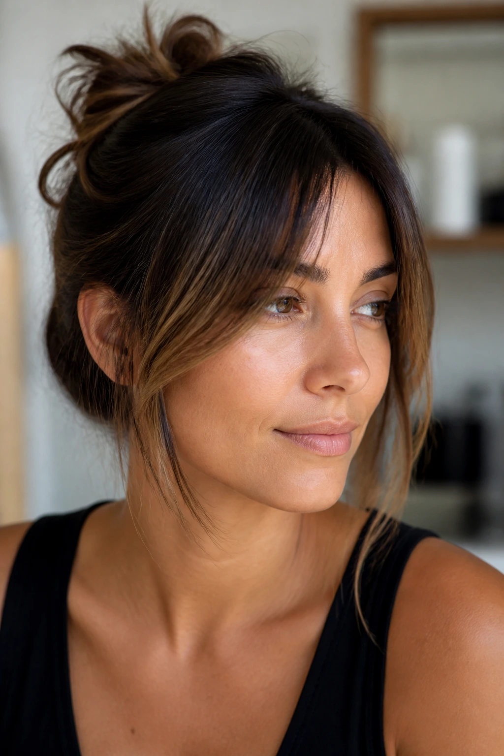 Close-up portrait of a real woman with face-framing fringe along the jawline.