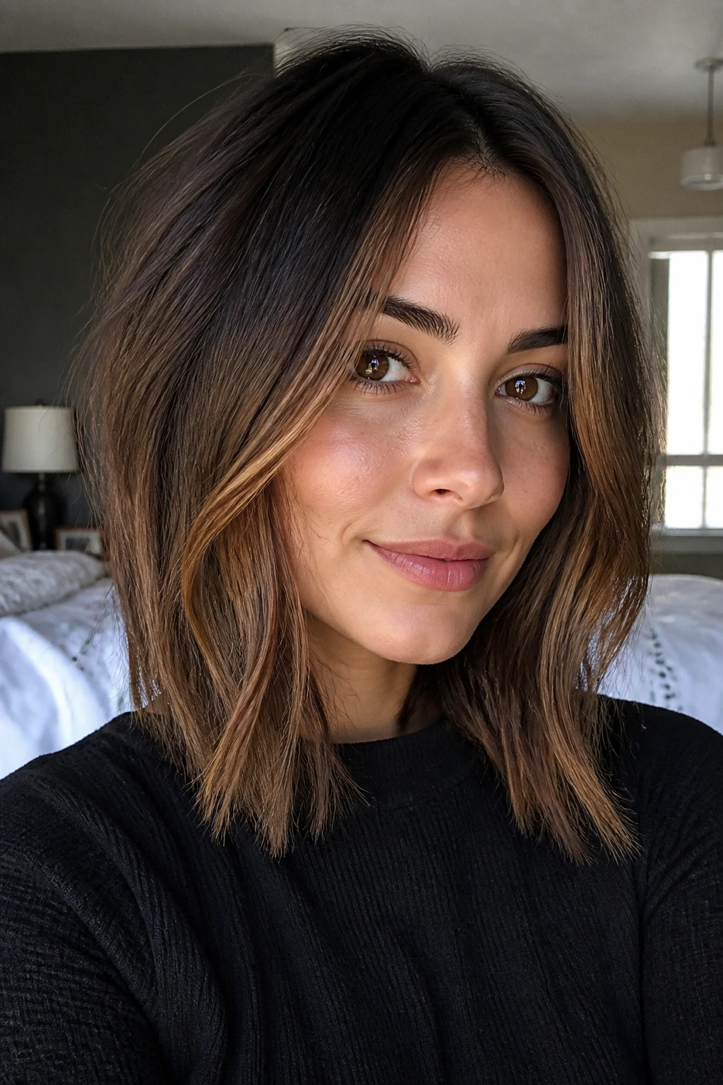 Close-up of a real person with face-framing lob front pieces in morning light