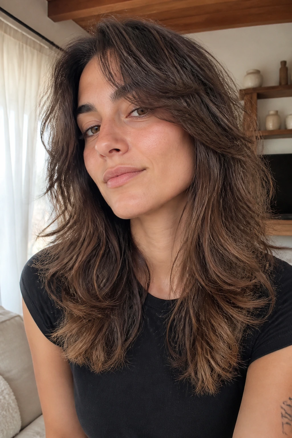 Close-up portrait of a real woman with feathered ends for wavy hair