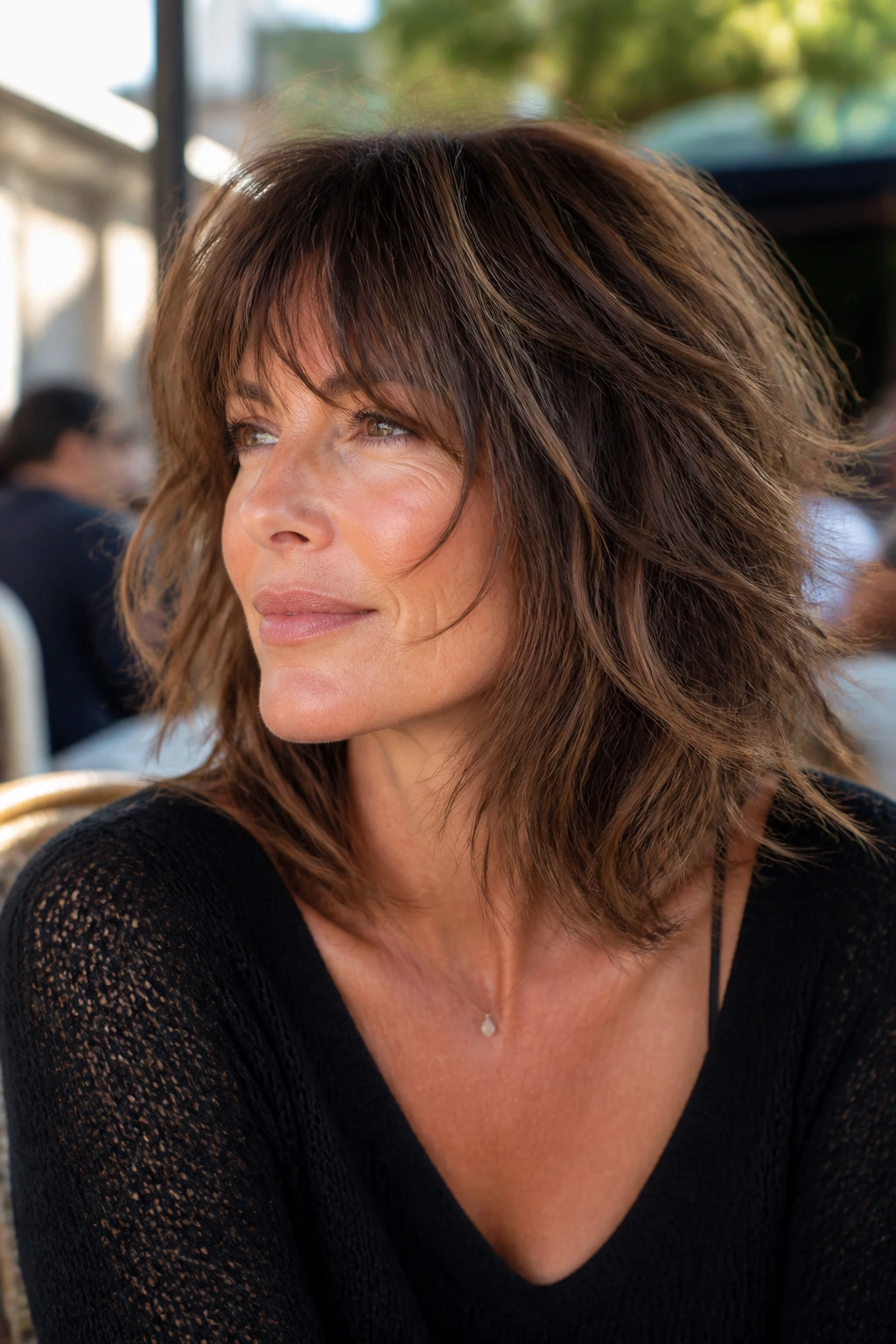 Portrait of a real woman with feathered shag fringe in outdoor daylight