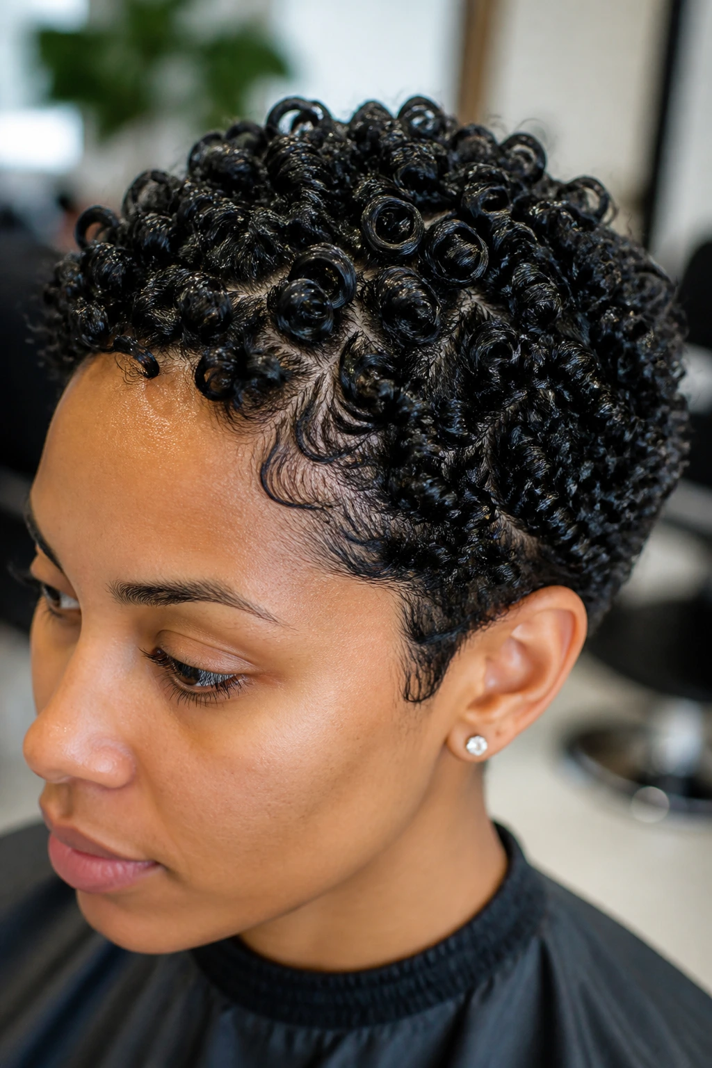 Close-up of defined finger-coiled curls on a short hairstyle
