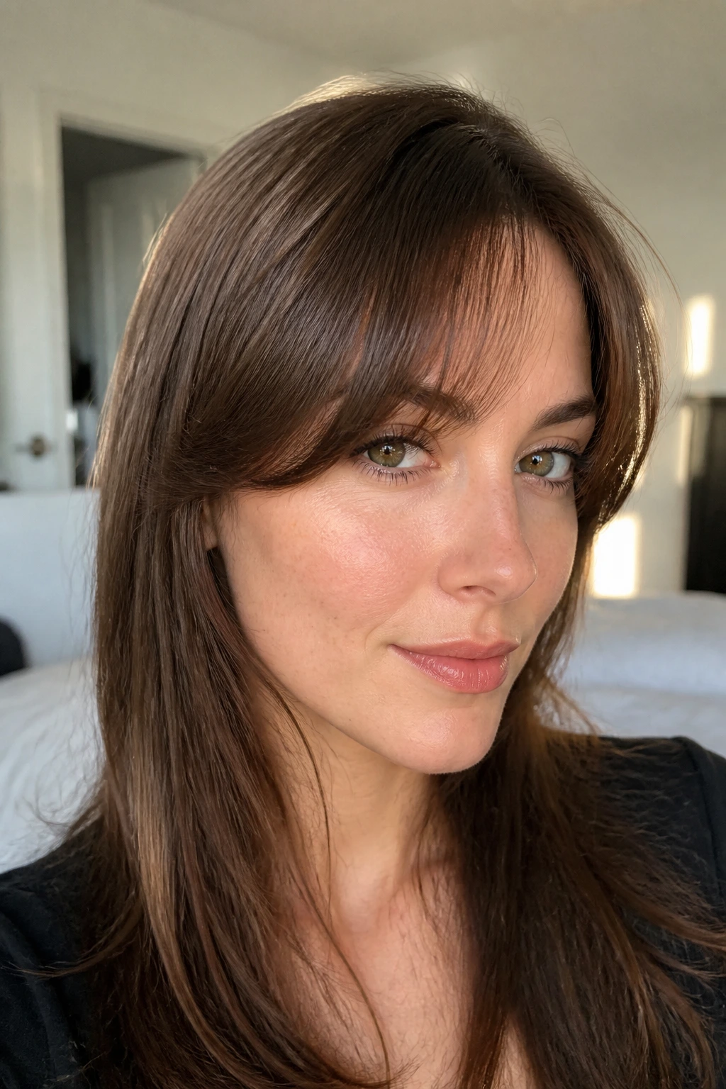 Close-up of a real woman with a flipped-under fringe and soft bend in morning light
