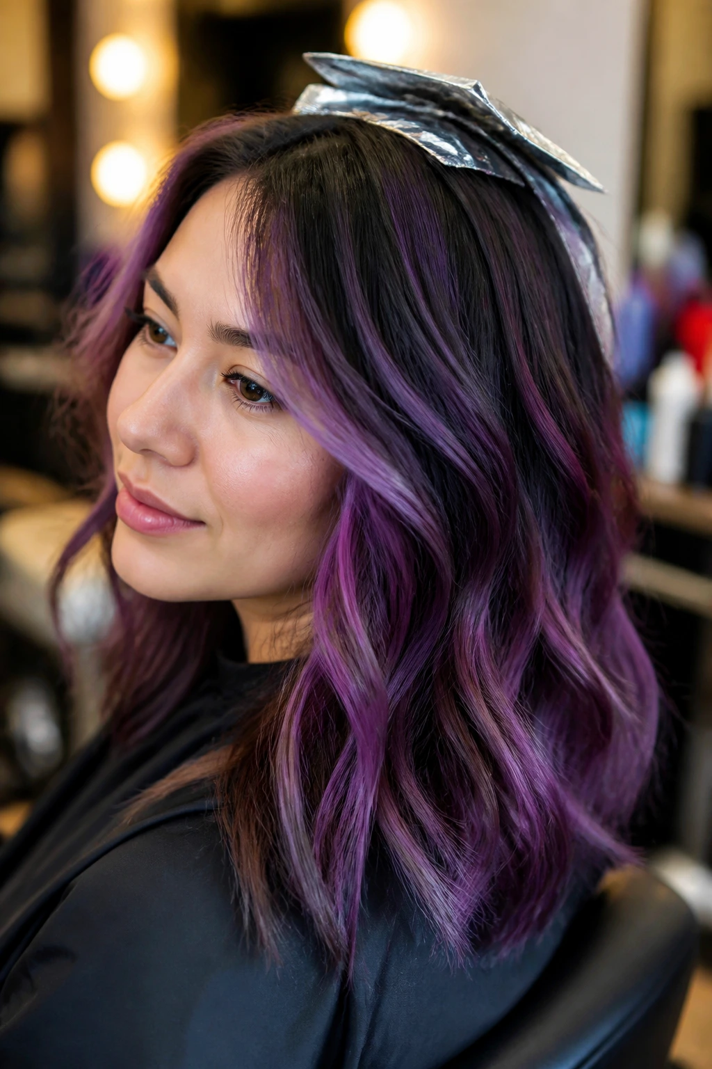 Real woman in salon chair with thoughtful expression and purple tones