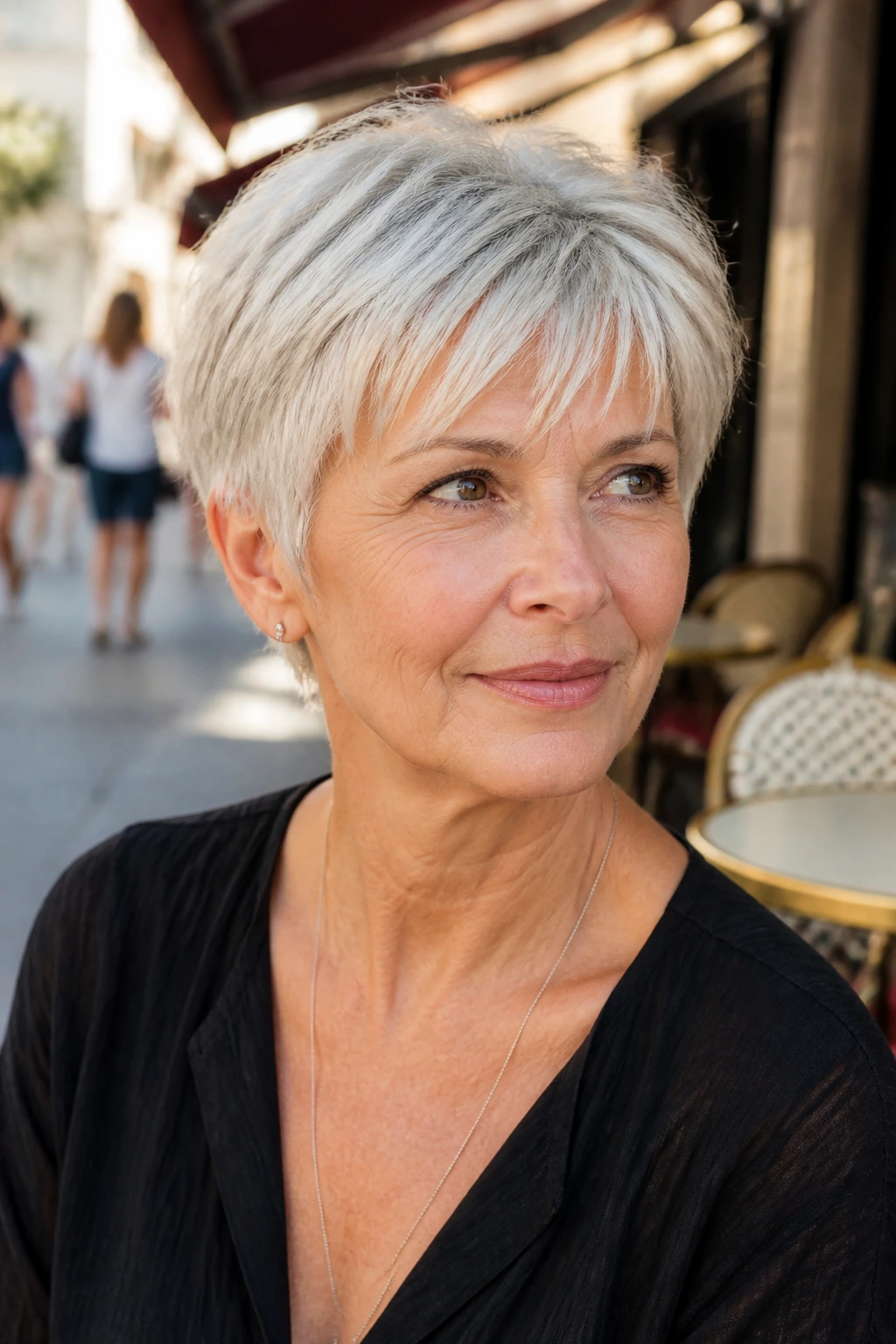 Portrait of a woman with a French pixie and airy fringe in natural daylight.