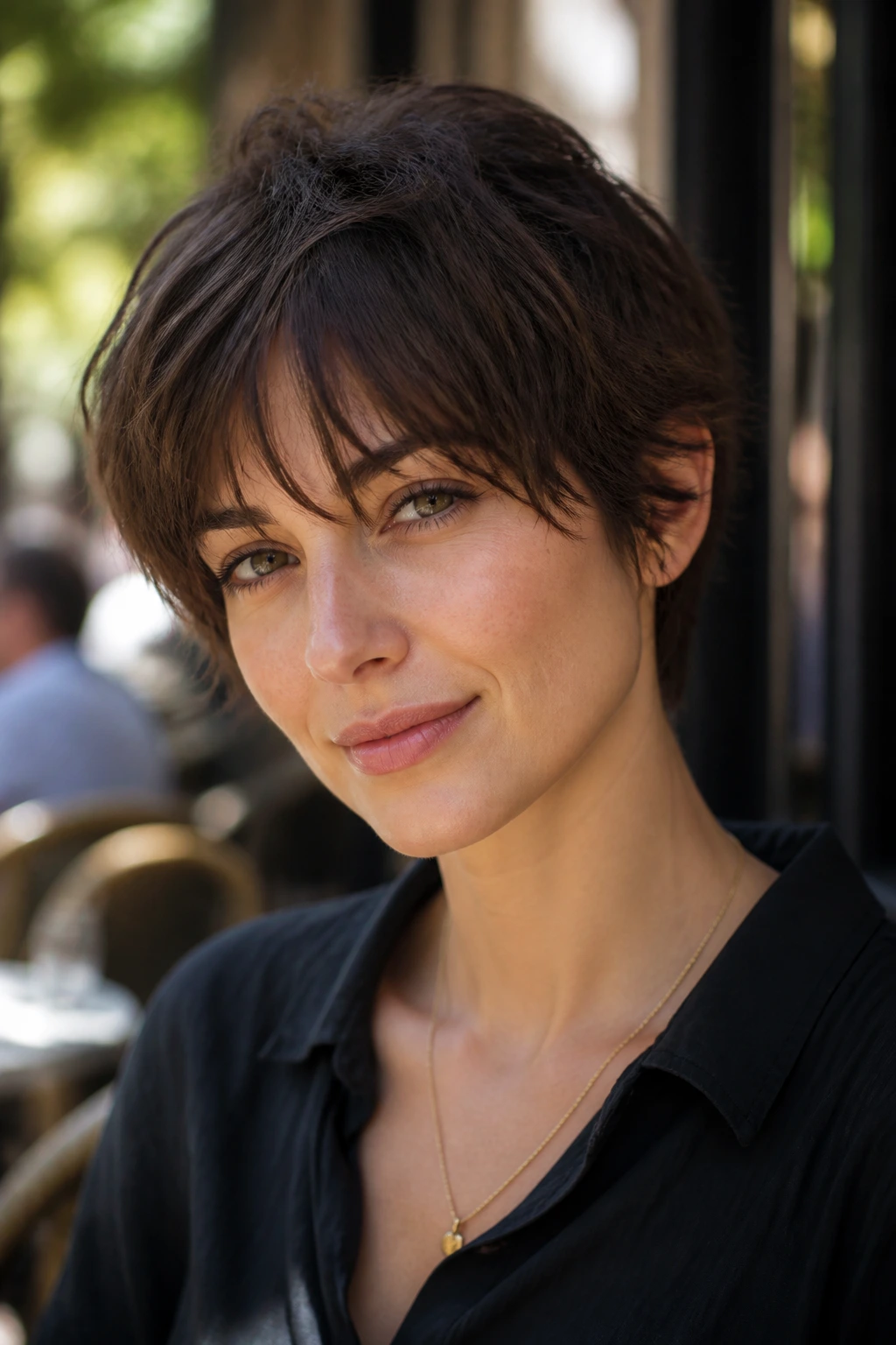 Close-up of a real woman with a soft French pixie and longer fringe.