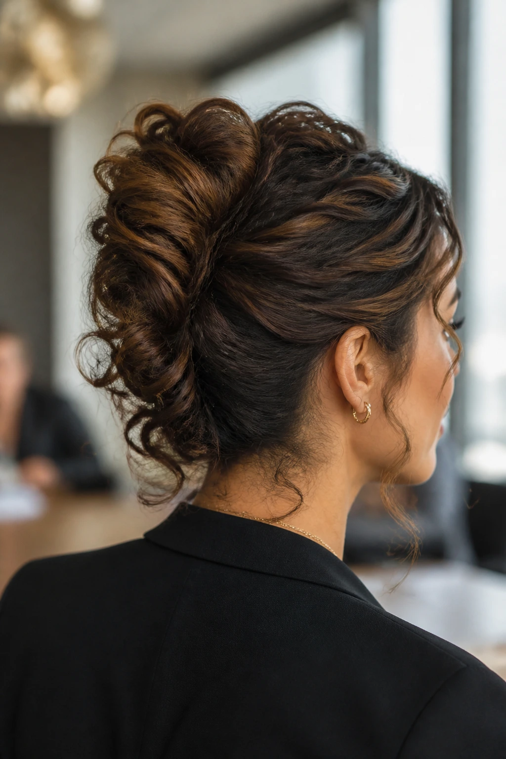 French twist with curly ends on a real woman in an office setting