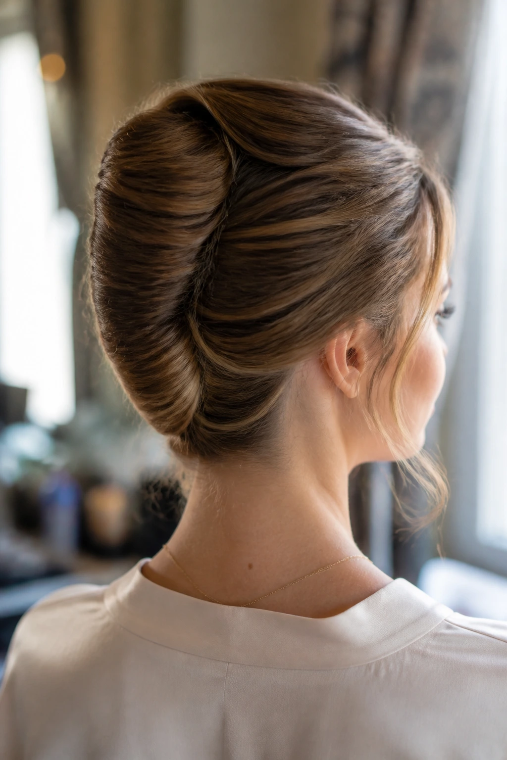 Close-up of a woman with a soft-edged French twist