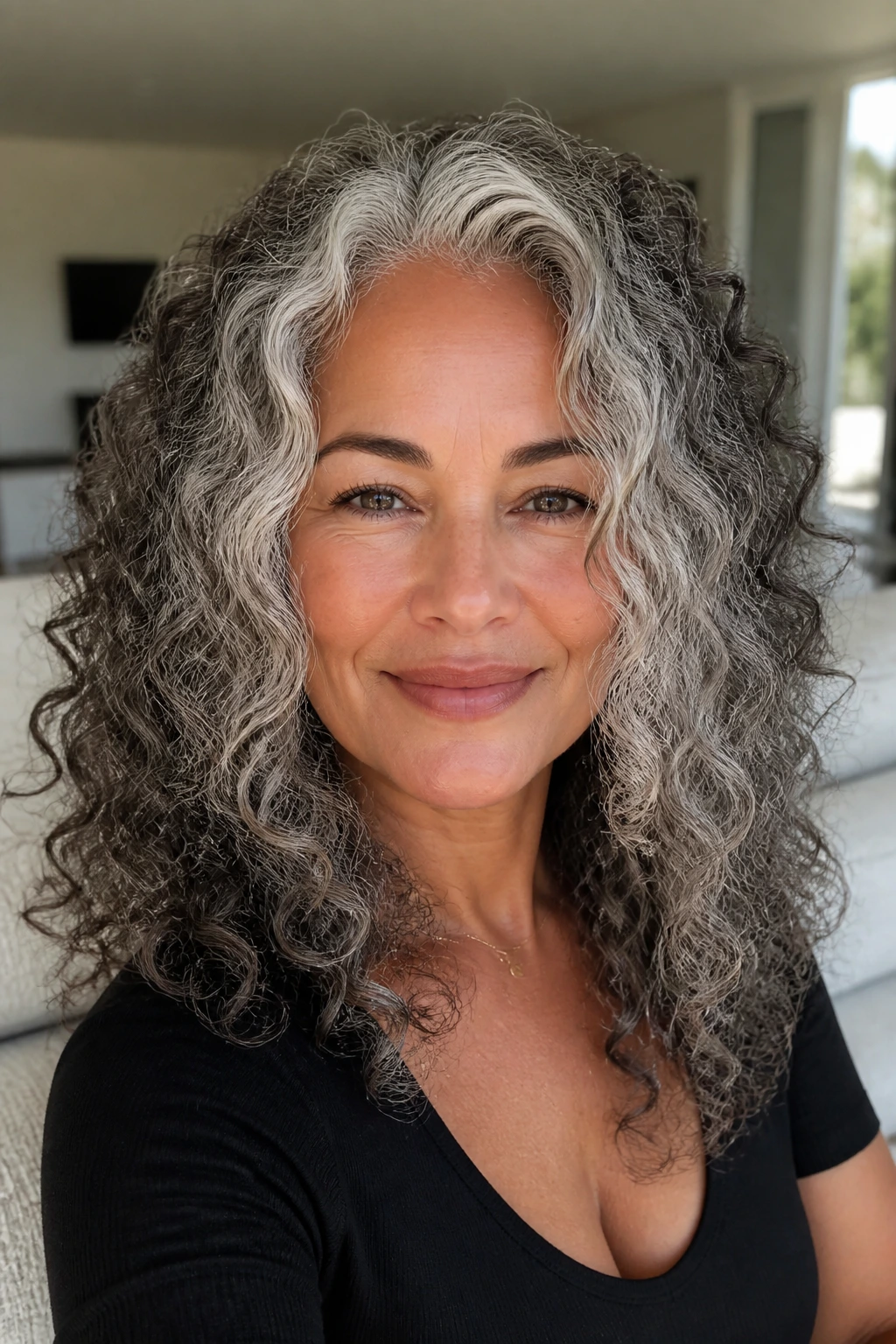 Real woman's curly hair with frosted money piece framing the face