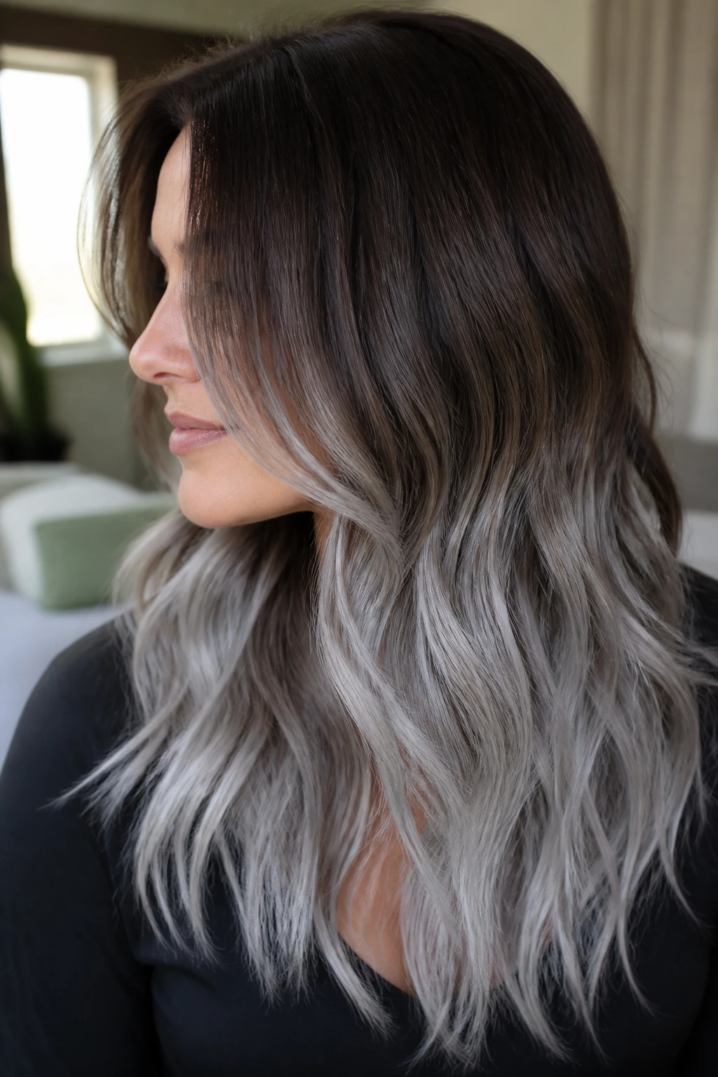 Close-up of a woman with frosted brunette-to-silver ombré and melted transition.