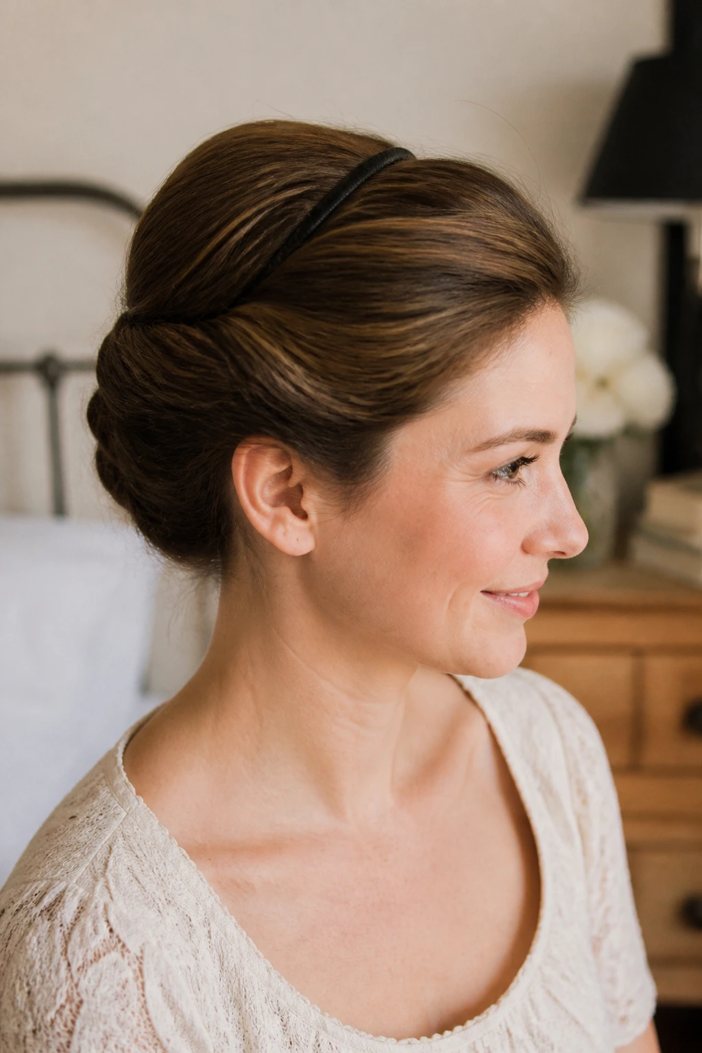 Close-up portrait of a woman with a Gibson tuck hairstyle.