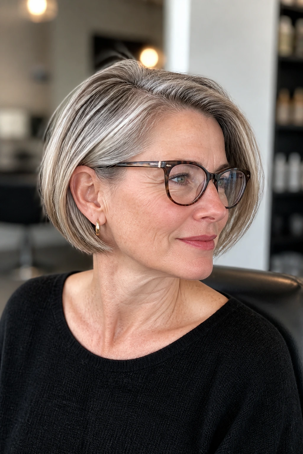 Close-up of a real woman with a chin-length glasses-friendly bob framing her glasses