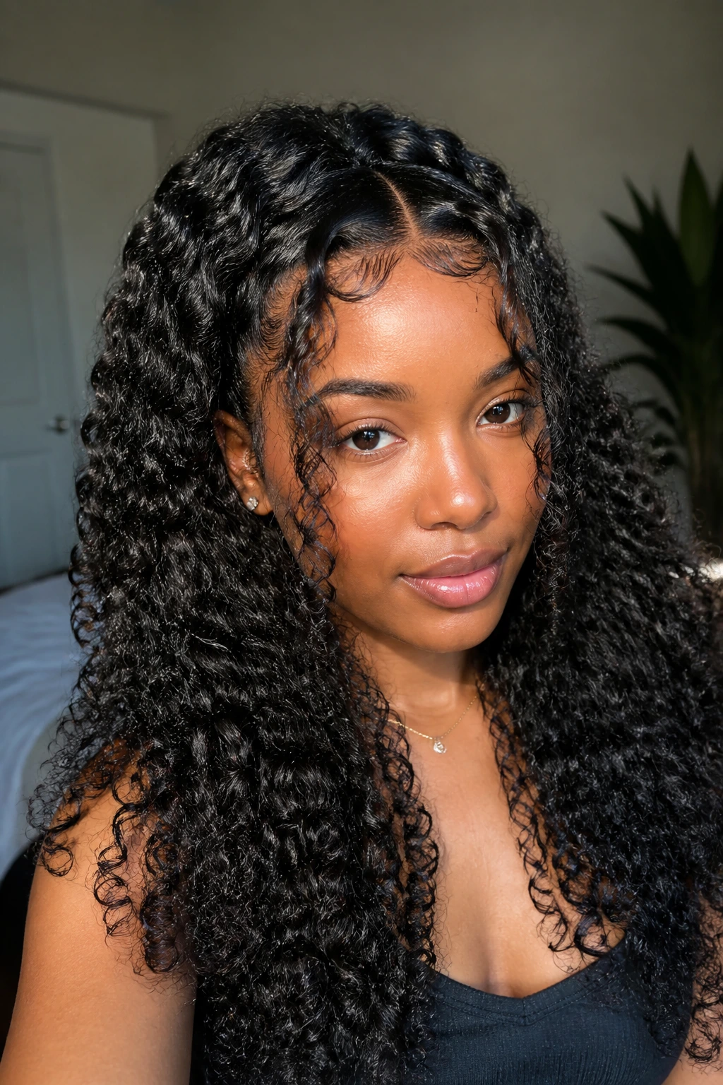 Close-up portrait of goddess curls with face-framing pieces on a real person