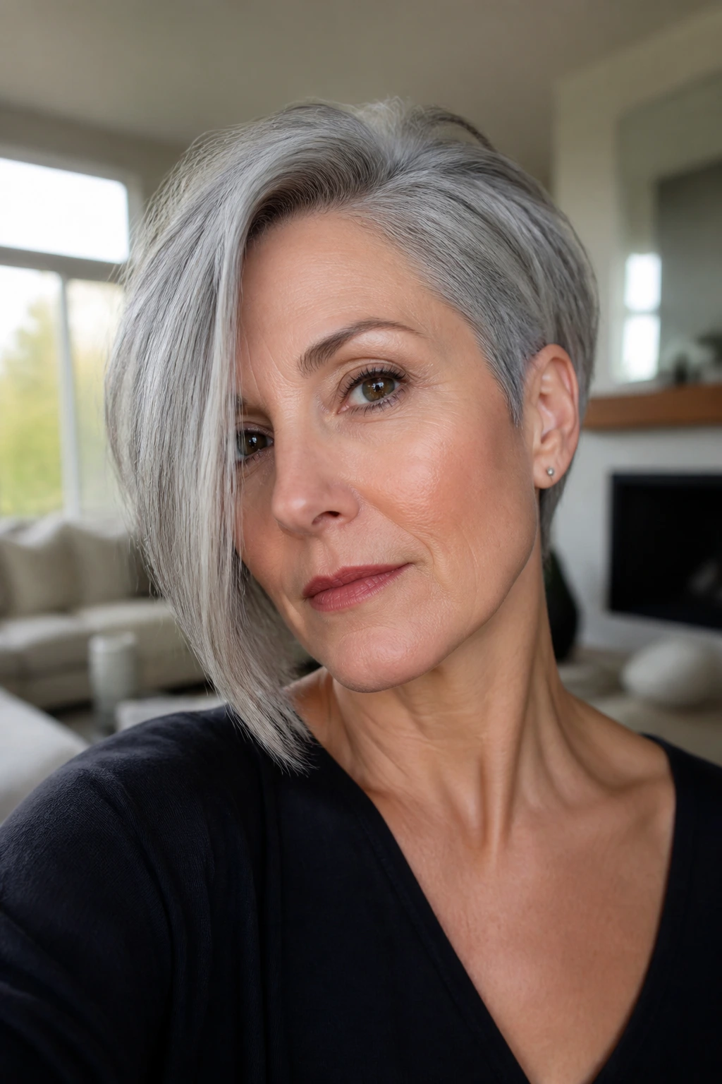 Close-up of a real woman with an asymmetrical gray bob and longer front pieces
