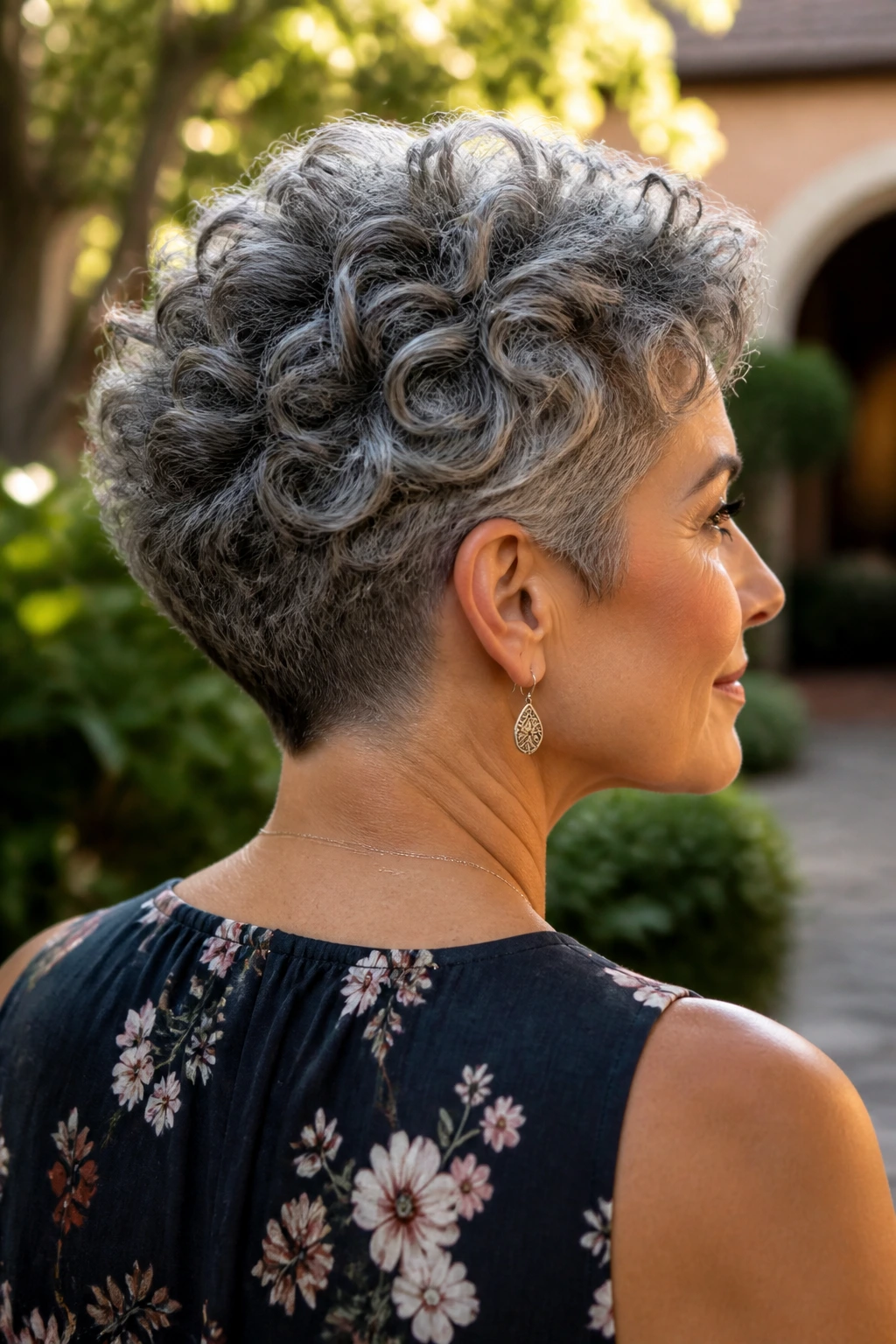 Close-up side-profile of a gray-haired woman showing a soft undercut at the nape with voluminous top