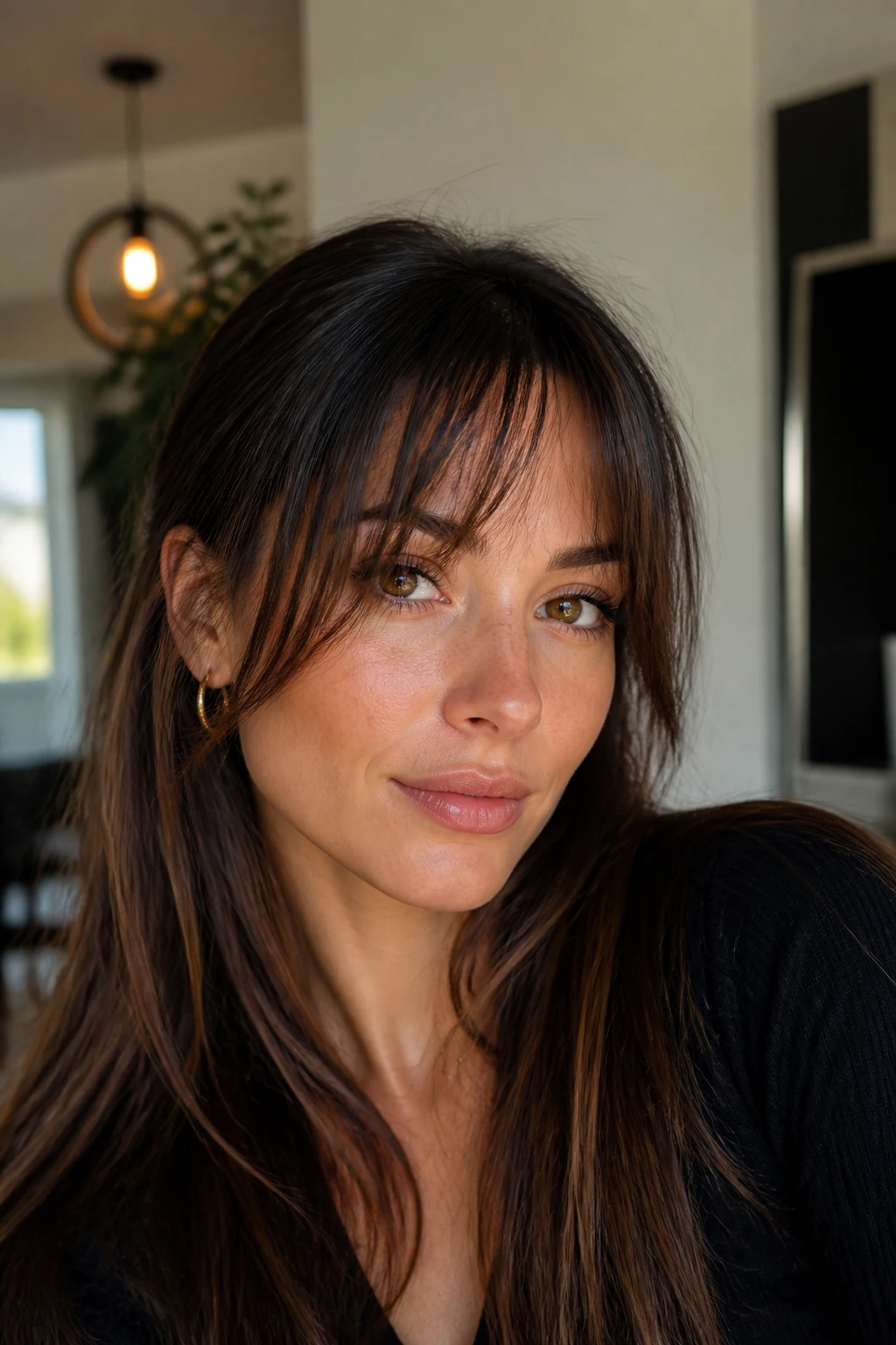 Portrait of a person with grown-out wispy bangs blending into front pieces