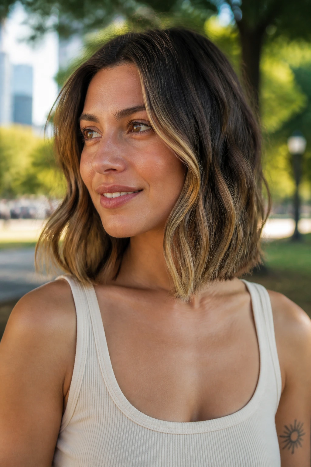 Close-up of real woman with grown-out bob lob in outdoor park light