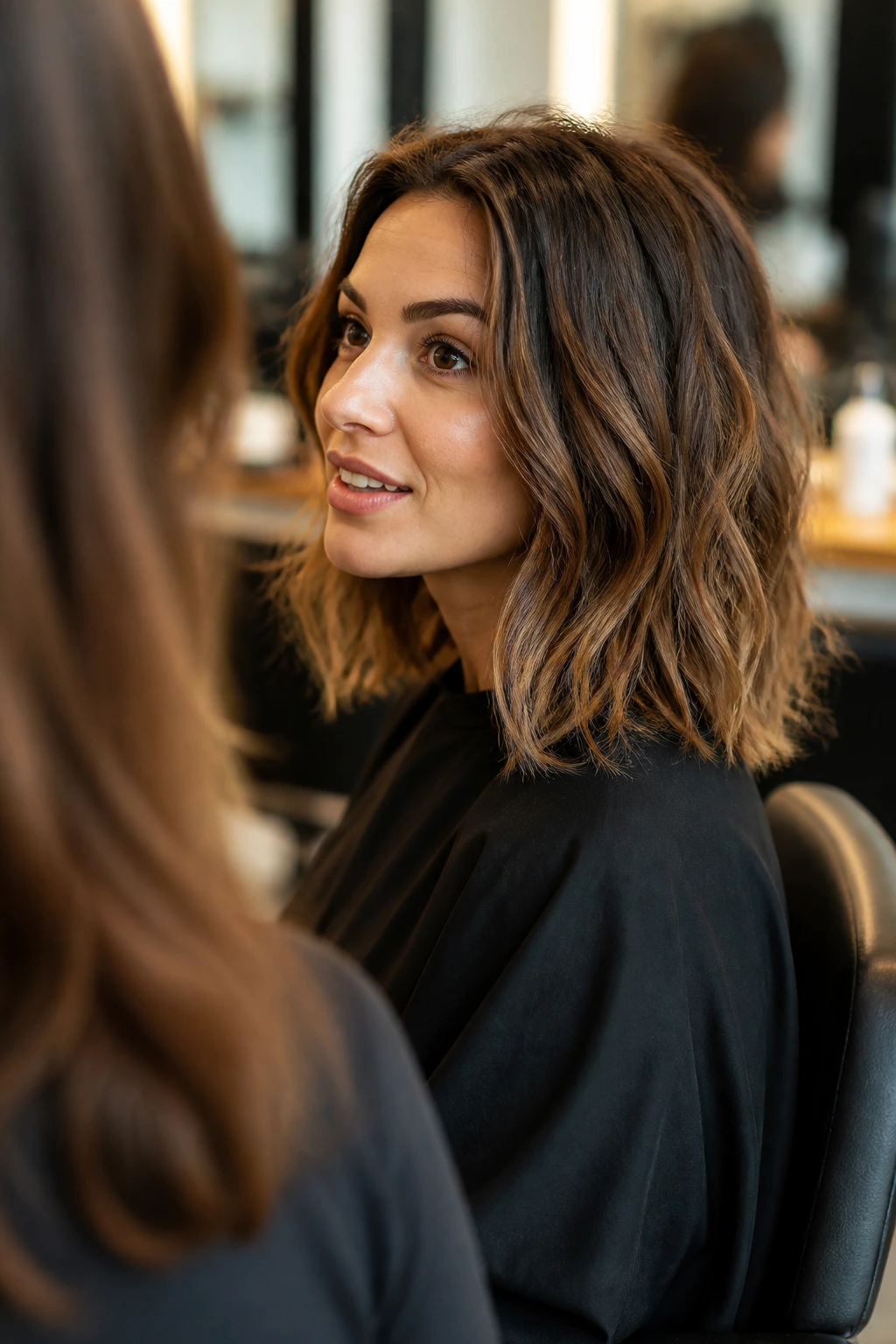 Portrait of a real woman in a salon chair discussing haircut with stylist