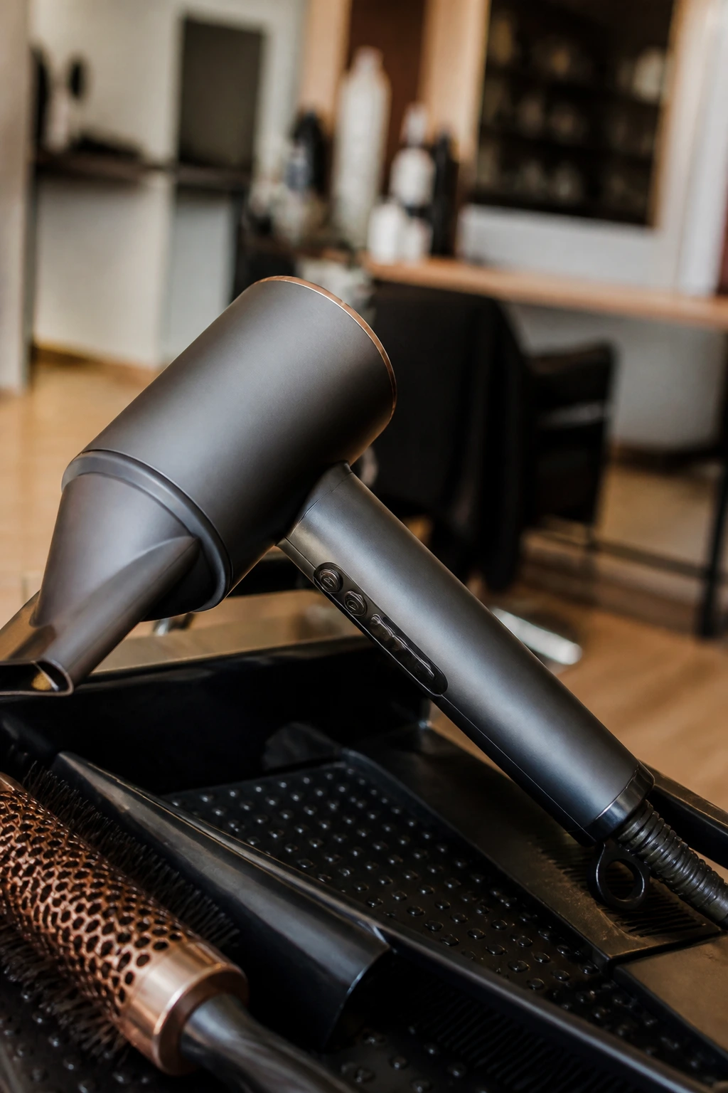 Close-up of a professional blow dryer nozzle in a salon setting.