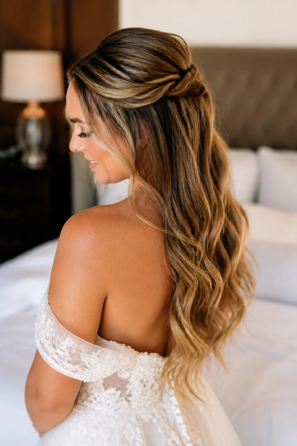Bride's half-up crown twist with tape-ins, three-quarter view