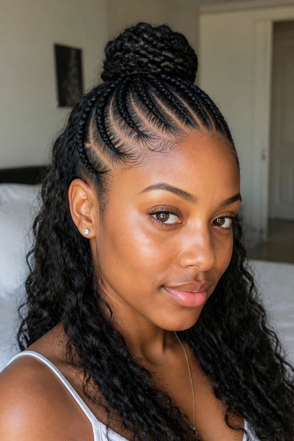 Real woman wearing half-up, half-down cornrows with a top knot