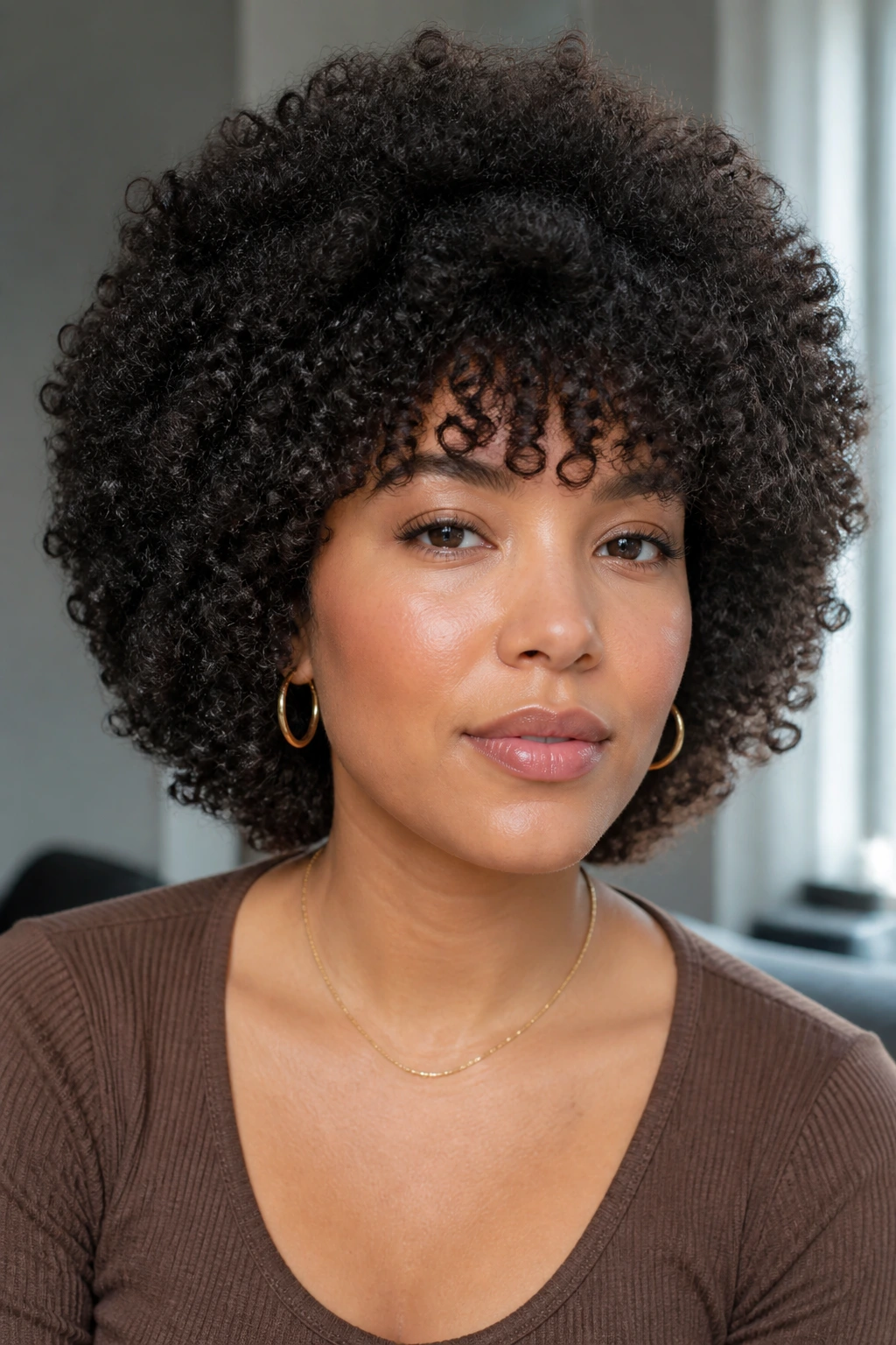 Close-up portrait of a real person with halo afro and curved bangs