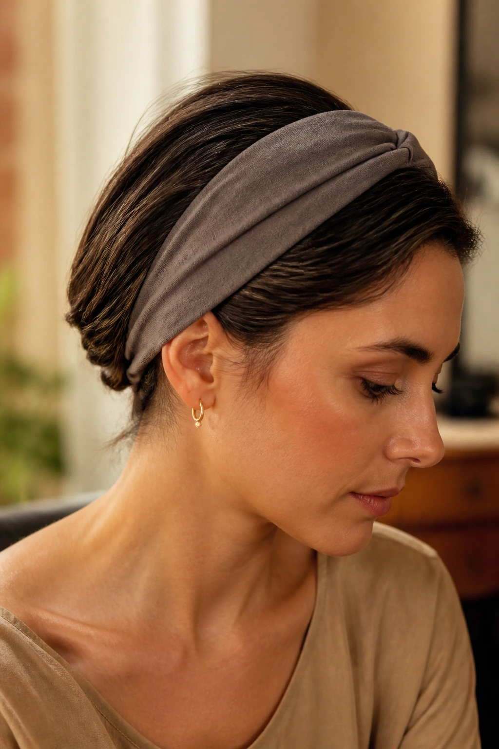 Close-up of a real woman with a headband tuck hairstyle at the nape