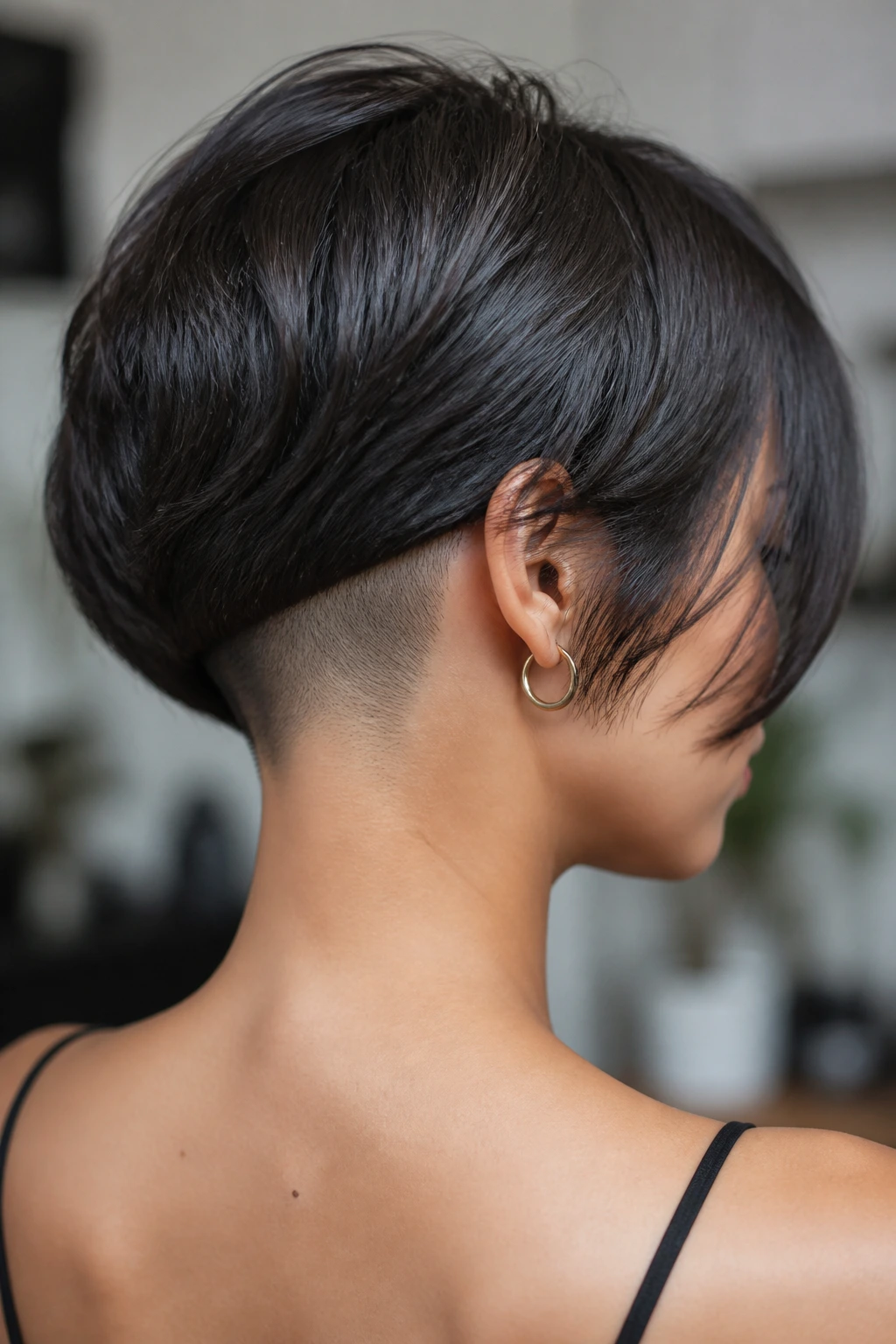 Portrait of a woman showing a hidden nape undercut beneath the top layer